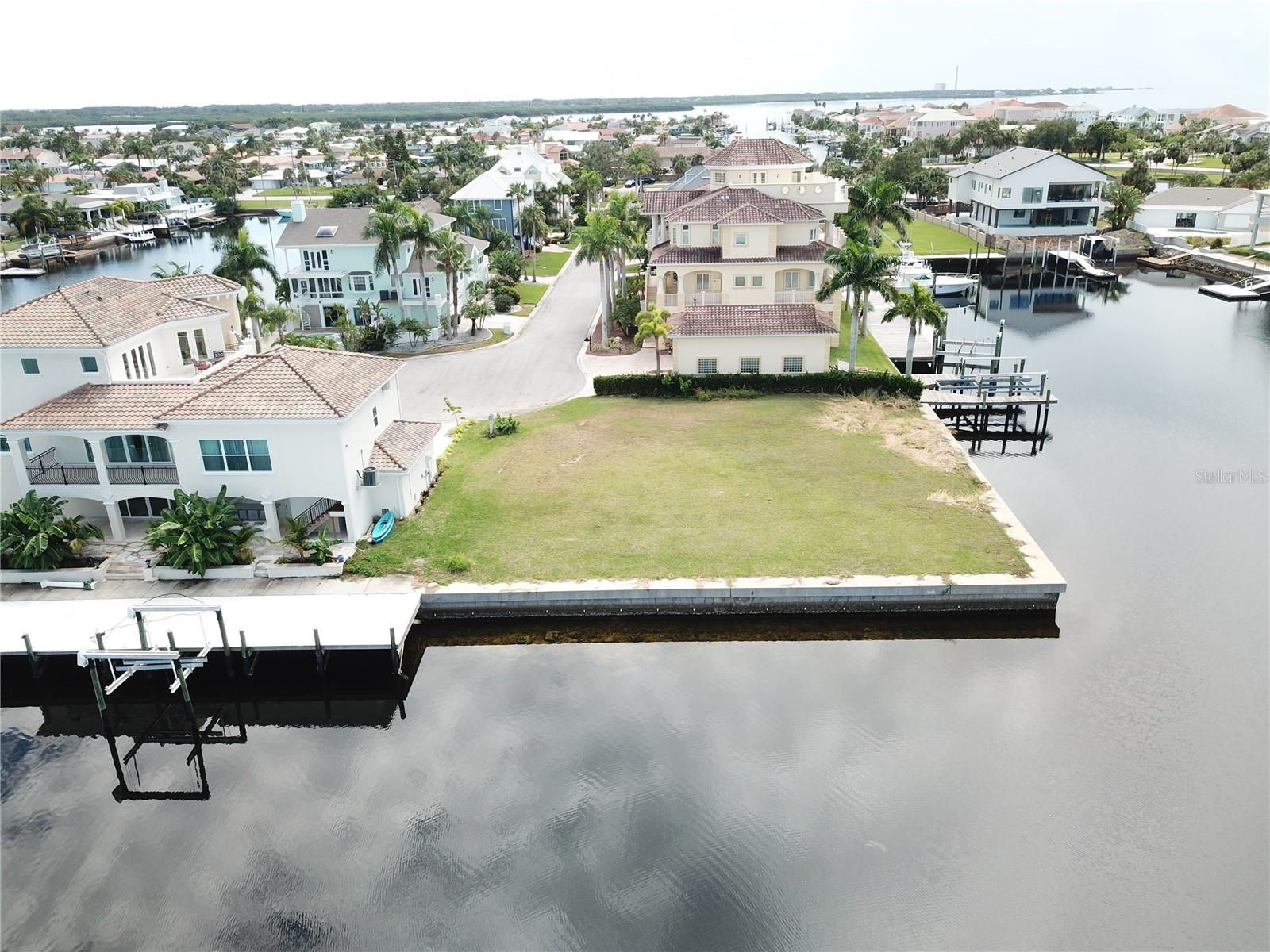 Experience breathtaking 360-degree, million-dollar views of wide-open water, with stunning sunrises and sunsets every day. This 198 ft. deep, sheltered waterfront lot sits just one block from the exclusive Gulf Harbors Private Beach Club, where membership is only $200 per year and gives you access to the community private pool (one of only two communities in the whole State of Florida with a private beach).
This is the last remaining lot in Pasco County with this level of frontage. Enjoy true sailboat-deep water with no bridges—just seconds to the open Gulf of Mexico.

The 10,021 sq. ft. homesite features 102.8 ft. of waterfront on the north side and 95.62 ft. on the west side, perfectly positioned on a quiet cul-de-sac within the gated community of Schooner Place/Gulf Harbors.
This property can accommodate docking for two 80+ ft. boats, offering a rare level of boating access and flexibility. The neighborhood showcases beautiful million-dollar homes, meticulously maintained landscaping, and a friendly golf-cart-friendly environment.
Located just 45 minutes northwest of Tampa Bay, you’ll enjoy quick access to the Gulf, a new seawall, and no time limit to build. Geotechnical testing and a survey have been completed and will convey with the sale.The seller will consider owner financing with terms to be negotiated.