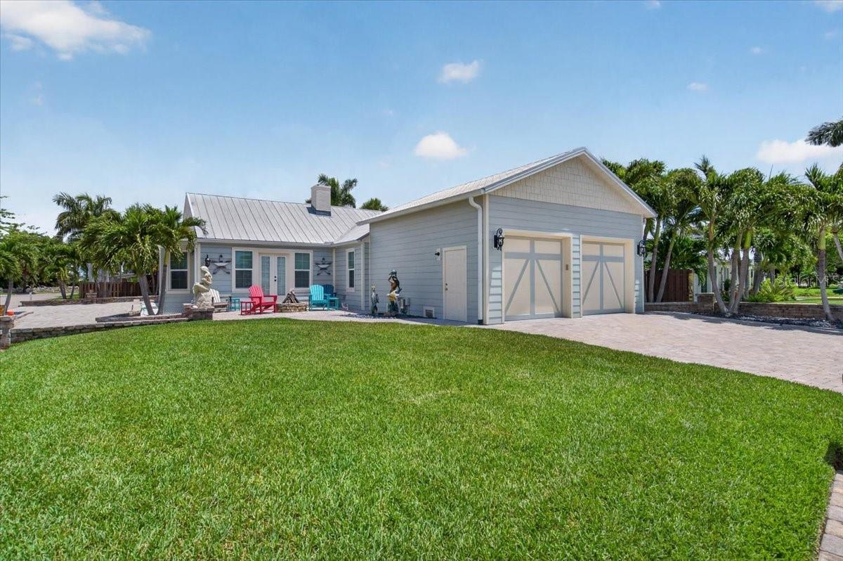 Welcome to 216 Sunrise Dr in Nokomis, FL! A one-of-a-kind waterfront estate designed for the discerning luxury buyer and true automotive enthusiast. Perfectly positioned on Roberts Bay with no bridges to the Bay or Gulf, this extraordinary residence combines coastal elegance, cutting-edge upgrades, and unmatched garage capacity in a private tropical setting. Built for both beauty and resilience, the home features over $80,000 in CAT5-rated PGT hurricane-impact windows and doors, new HVAC systems raised for protection, all-new PVC re-piping completed in 2024/2025, updated electrical throughout, and a hybrid septic system replaced approximately three years ago. The roof has been professionally re-screwed and resealed, while the entire home has been enhanced with sprayed foam insulation across all attic spaces for superior efficiency.

Inside, warm luxury details define the living spaces, including stunning wood accent walls, remodeled bathrooms, custom kitchen features, a spacious primary bath shower, Glor and More blinds, tankless instant hot water system (2025), ventless remote-controlled fireplace, and over 11 closets plus a walk-up loft attic with generous walkable space for exceptional storage, hobbies or future customization. Historic character meets modern refinement with a bundle of aged red oak flooring included.

Outside, the grounds rival a private resort with over $200,000 invested in pavers, extensive lighting, and professionally designed landscaping featuring approximately $70,000 in nighttime illumination. Additional exterior highlights include a new fence, Mexican black river rock accents, irrigation systems utilizing both well and county water, underground gutter systems, a fountain, fire pit with updated tanks and hoses, outdoor utility sink, grill area, and sandy-bottom waterfront access.

For boating enthusiasts, the property offers one of the area’s largest mooring dock setups, a 10,000-lb boat lift, two brand-new multi-level jet ski lifts, remote-controlled lifts, underwater survey completed, dock lighting, and regularly maintained mangroves. Enjoy direct boating access with no bridges to the Bay or Gulf.

The ultimate car lover’s paradise, this estate features up to 6-car garage capacity with taller 4-car garage bays, exotic-car-compatible wide lifts, side-mount garage doors, silent openers, epoxy flooring, mini-split climate systems, block garage construction, and foam insulation throughout. Every detail was designed with collectors and enthusiasts in mind.

Additional features include: New interior and exterior Rain Refresh paint, Brand-new irrigation pump, Hurricane-rated upgrades throughout, Utility well servicing property irrigation, Block and Hardie board exterior construction, Raised back door elevation approximately 3.5 feet above sea level, Termite tenting completed approximately 5 years ago, Three septic tanks located on right side yard, Updated shell landscaping and hardscape finishes. Attention to detail was not missed, every upgrade was done with thought and cost was not spared!

216 Sunrise Drive is a rare opportunity to own an extensively upgraded waterfront retreat where luxury living, boating lifestyle, and exotic car storage converge into one exceptional property. Schedule your private showing today!