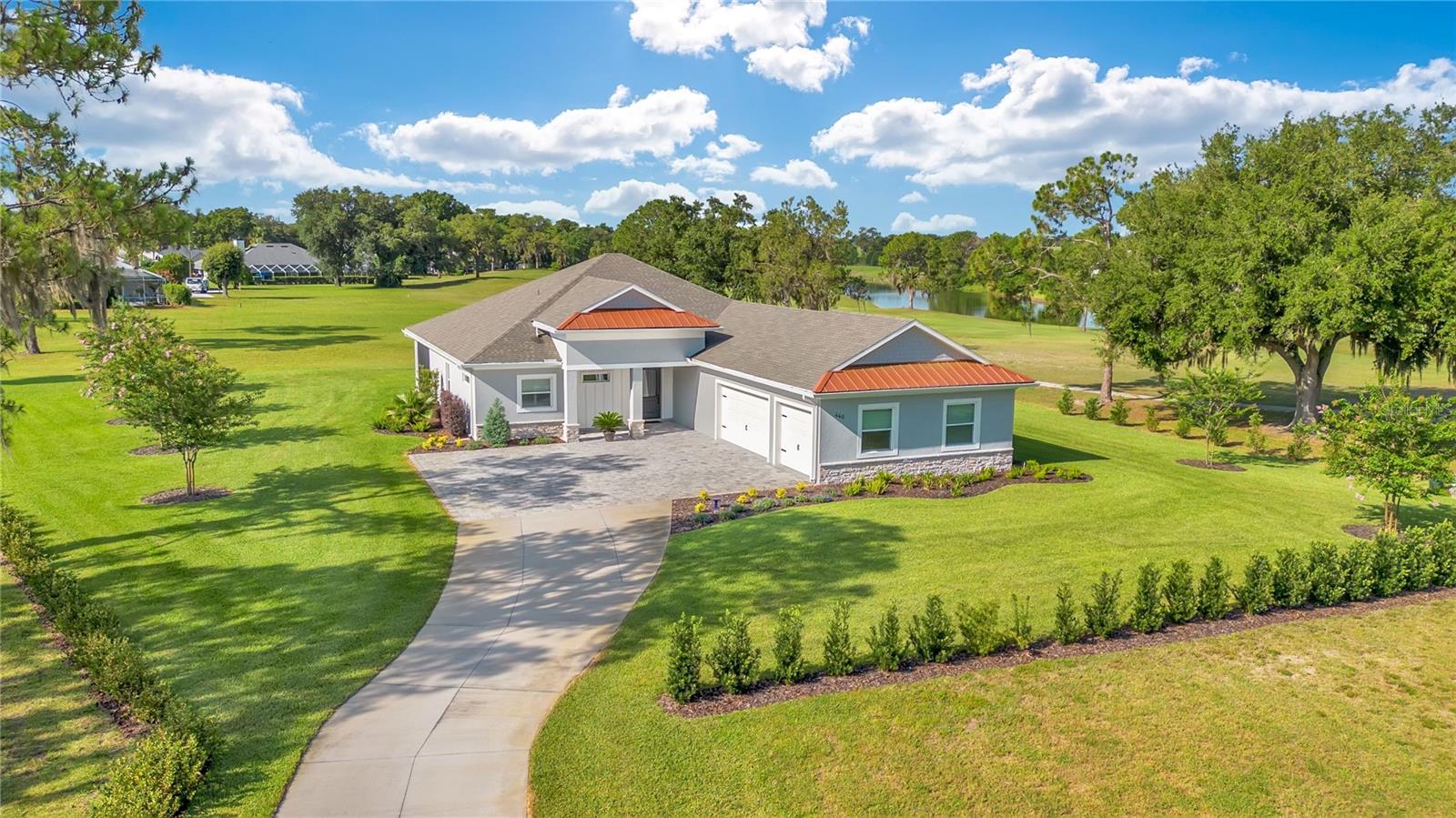 Over 1 Acre with Golf Course Views in Cypresswood Golf & Country Club. Discover a rare opportunity to own one of the LARGEST residential lots in Cypresswood Golf & Country Club, one of Winter Haven's premier gated golf communities. Built in 2023 and situated on 1.17 acres, this exceptional 4-bedroom, 3-bathroom residence offers luxury, privacy, and modern living with expansive views of the 2nd green and 9th tee of the Ron Garl-designed championship golf course.

A long private driveway lined with Florida-friendly landscaping leads to an expansive paver parking courtyard and oversized three-car garage featuring a professionally finished epoxy floor. Ebony-finished tongue-and-groove ceilings on both the front entry and rear screened lanai create an impressive first impression, while the Therma-Tru insulated front door with decorative glass insert welcomes you inside.
The thoughtfully designed OPEN-CONCEPT FLOOR PLAN features luxury vinyl plank flooring throughout, soaring ceilings with decorative beam details, custom millwork, recessed lighting, and large windows that fill the home with natural light. The spacious great room is anchored by a custom shiplap feature wall with an electric fireplace and opens seamlessly to the covered lanai through oversized sliding glass doors. A premium Denon surround sound system serves both the great room and lanai, making entertaining effortless.

The gourmet kitchen combines style and functionality with quartz countertops, a large center island, solid wood cabinetry, under-cabinet lighting, a walk-in pantry with custom shelving, Frigidaire Professional Series stainless steel appliances, and a natural gas cooktop.
The spacious primary suite offers a tray ceiling with decorative beams, an oversized walk-in closet, and a luxurious ensuite bath featuring dual vanities, a garden tub, walk-in shower, and private water closet. The split-bedroom floor plan provides privacy for family and guests, and every bedroom includes a walk-in closet.

Step outside and enjoy the freedom of owning more than an acre with panoramic golf course views and plenty of room to create your dream outdoor living space. Residents of Cypresswood Golf & Country Club enjoy an 18-hole championship golf course, clubhouse, restaurant, junior Olympic-sized pool, tennis and pickleball courts, and scenic roads perfect for walking, running, and biking. Conveniently located near US-27, I-4, the Polk Parkway, downtown Winter Haven, and LEGOLAND Florida Resort, this home offers an exceptional combination of luxury, space, and location.