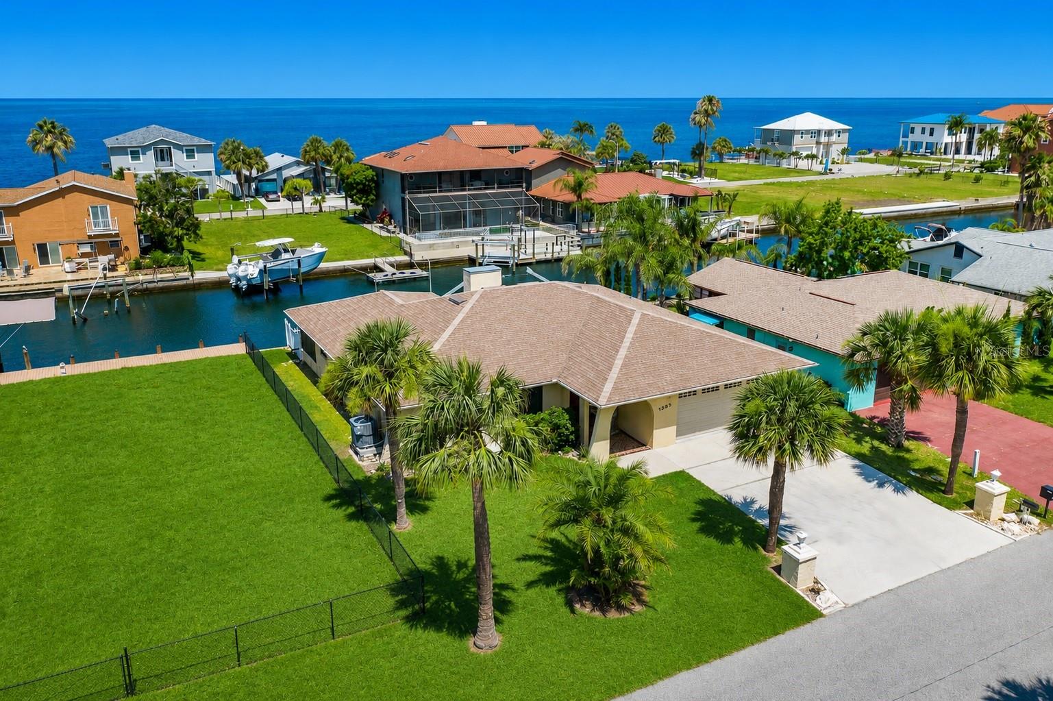 WATERFRONT LIVING AT ITS FINEST! Welcome to 13525 Claudia Drive, ideally situated within Sea Ranch on the Gulf, one of Hudson's most desirable waterfront communities. This exceptional updated three-bedroom, three-bathroom waterfront pool residence with a two-car garage is nestled on a quiet cul-de-sac and offers 70 feet of deep-water frontage with direct, unobstructed access to the Gulf waters. Located just approximately 250 feet from open water, this is a dream property for boating enthusiasts. Bring your sailboat, yacht, fishing boat, or multiple watercraft because this home is truly a boater's paradise. Positioned on an oversized 70' x 100' waterfront lot with an elevation higher than many surrounding waterfront properties, this home offers an added advantage while still enjoying exceptional Gulf access. Beautifully updated throughout, this light and bright residence features a highly desirable split-bedroom floor plan with dual primary suites, each offering private en-suite bathrooms—perfect for multigenerational living, hosting guests, or creating a luxurious owner's retreat. The spacious living room is enhanced by skylights that flood the home with abundant natural light, creating an open, airy, and inviting atmosphere. Step outside and experience the very best of Florida's waterfront lifestyle. Spend your evenings enjoying breathtaking sunset views over the Gulf, cast a line and enjoy great fishing right from your backyard, or simply relax and watch dolphins and manatees gracefully swim by. The peaceful setting and exceptional boating access create a lifestyle that feels like a year-round vacation. Additional highlights include underground utilities with no obstructing power poles, solar screens for enhanced energy efficiency and comfort, and a location on one of the neighborhood's quieter streets. Conveniently located just minutes from shopping, waterfront bars, restaurants, entertainment, marinas, medical facilities, and everyday conveniences, this home also offers easy access to major airports and surrounding areas. Whether you're searching for a primary residence, seasonal getaway, or investment opportunity, this exceptional property offers the perfect combination of updated coastal living, deep-water Gulf access, and the relaxed waterfront lifestyle that makes Sea Ranch on the Gulf one of Hudson's premier waterfront communities. Call today to schedule your private showing and experience Florida waterfront living at its finest!