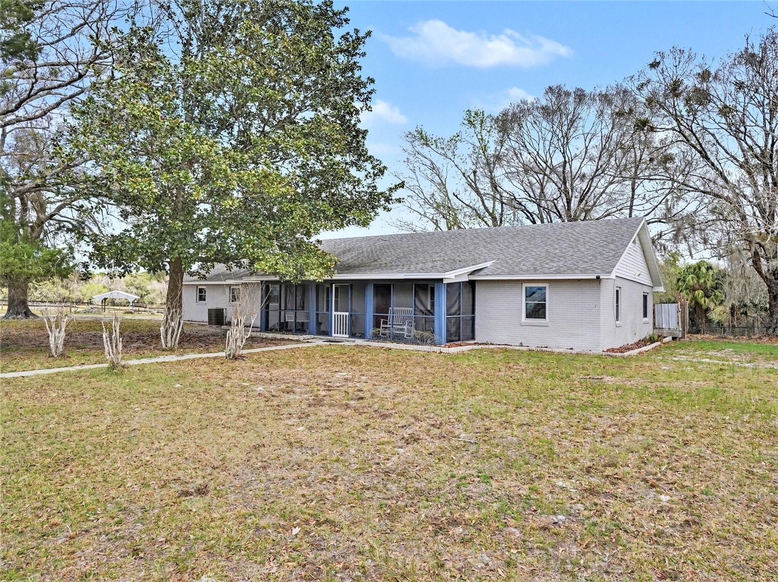 Seller is offering a complimentary 0-1 Interest Rate Buydown through June 30, 2026, exclusively through Heart Mortgage for qualified buyers, creating an opportunity for lower monthly payments and improved affordability. Payment scenario available upon request. 

Welcome to your 5-acre country retreat in Central Florida! This stunning ranch-style block home is less than five minutes from I-4, offering the perfect blend of privacy, space, and accessibility.

The property features a custom-built deck, private drive, and a Morton building that can easily be converted into a barn with stalls, workshop, or storage for equipment and toys. The 5 acres of improved pasture are fully fenced, located in Flood Zone X, and bordered by a new fence line along the northern edge to be completed prior to closing. The land boasts mature oak, sweet gum, magnolia, and maple trees, abundant wildlife, and a mixture of improved and native grasses, adjacent to the Blue Spring Basin. *Cattle, portable panels, feed bunks and liquid feed tanks Do Not Convey. 

Step inside to a spacious eat-in kitchen with new granite countertops, a gunmetal sink and faucet, two pantries, and beautifully refinished solid wood cabinetry, with room for an eight-person dining table. The oversized family room features an authentic river rock fireplace and striking pecky cypress walls, while French doors open to the Florida Room, recently refloored and freshly painted, offering bright, versatile space for relaxing, reading, or enjoying morning coffee. The primary bedroom is generously sized, with an ensuite that includes a new vanity, mirror, and toilet. Throughout the home, you’ll find plantation shutters, new ceiling fans and light fixtures, and freshly painted interiors, including ceilings, creating a warm and inviting atmosphere.

Savor west-facing sunsets from the front porch with a glass of wine, and wake up to east-facing sunrises from the back, including the Florida Room, with your morning coffee. Additional outdoor living spaces include a deck, enclosed patio, screened porch, and inviting front porch, perfect for entertaining or enjoying quiet moments outdoors.

The entire home, including the garage, features $32,000 in new VIWINCO High Energy Performance, wind-rated windows with a fully transferable lifetime warranty. The roof was replaced in 2017, and a new hot water heater will be installed prior to closing.

Located outside city limits with no HOA, this property allows room for animals, boats, RVs, and other recreational toys, with cable and trash service available. For those seeking even more land, an adjoining sister parcel totaling 10+ acres is available for purchase separately (MLS #O6355586 – vacant land), offering additional flexibility and expansion potential.

Don’t miss the opportunity to experience this private, spacious, and versatile country retreat — your perfect home awaits!
***Seller may contribute up to $10,000 toward buyer closing costs, prepaid expenses, or interest rate buy-down***
