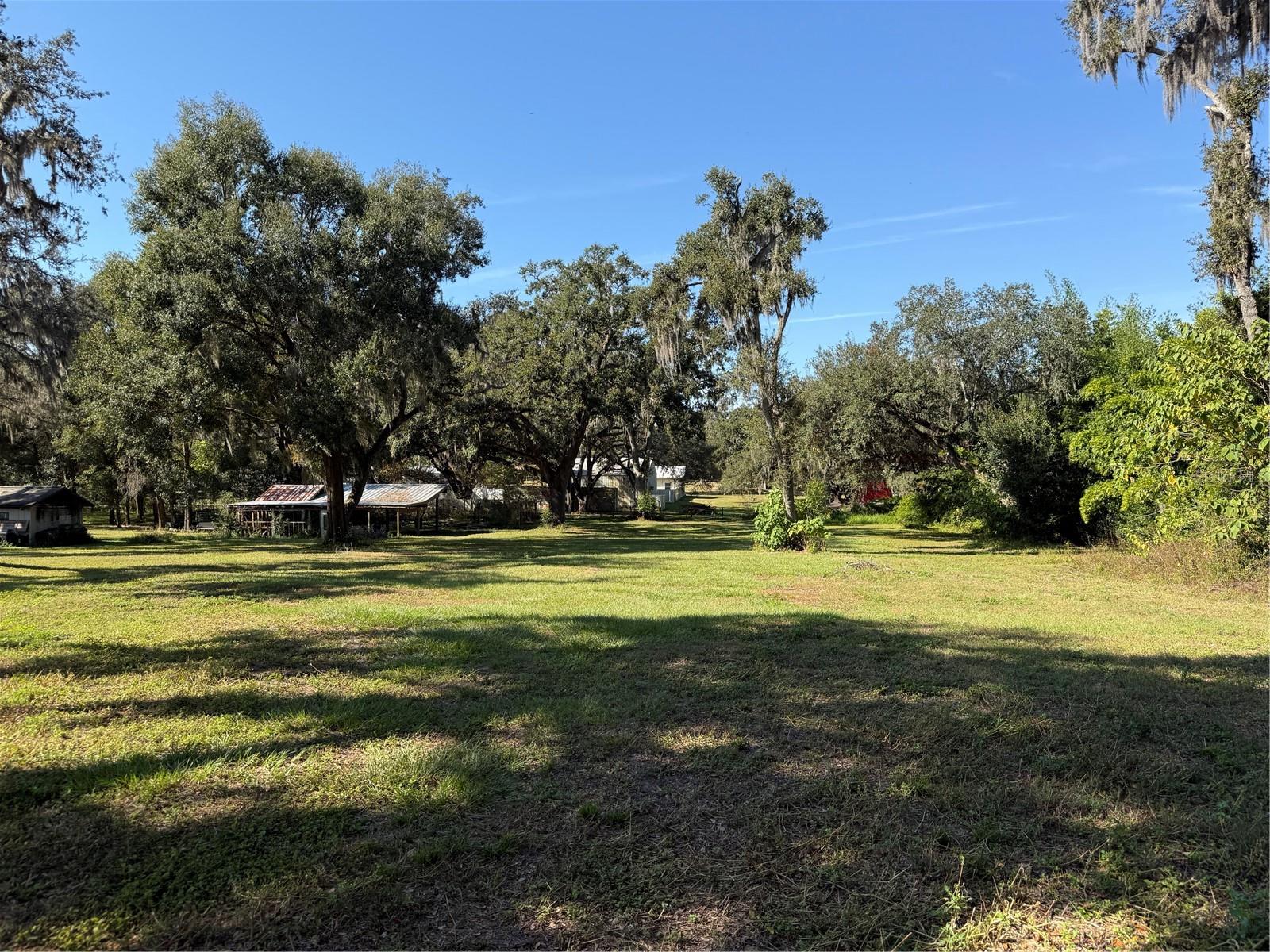 ***Owner Financing Available*** Build your dream home on this rare 1.51-acre vacant lot in desirable Dade City, offering the perfect blend of peaceful country living and everyday convenience. Ideally located just minutes from Wesley Chapel and Zephyrhills, you’ll enjoy easy access to shopping, dining, medical facilities, and major roadways while still embracing the privacy and space of rural life.

This oversized parcel provides ample room for your custom home, outdoor living space, and more. A private workshop/mini pole barn is already in place — perfect for equipment storage, hobbies, or future project space. Utilities including electricity, high-speed internet, and public water are available nearby (septic required).

Zoned AR (Agricultural Residential) with no HOA and located in Flood Zone X, the property offers flexibility with minimal restrictions. Access is secured via a deeded easement, and the lot sits adjacent to a charming horse ranch — an ideal setting for equestrian enthusiasts or anyone seeking a serene lifestyle just minutes from downtown Dade City.

Conveniently close to downtown Dade City, local hospitals, medical practices, and shopping centers including Zephyrhills Commons, Morningside Plaza, and Merchants Square, this property offers the space you want without sacrificing the conveniences you need. Centennial Middle and Elementary STEM Magnet schools are a short 2.5 mile drive.

A rare opportunity to build in a growing area while still enjoying the charm of Old Florida living.