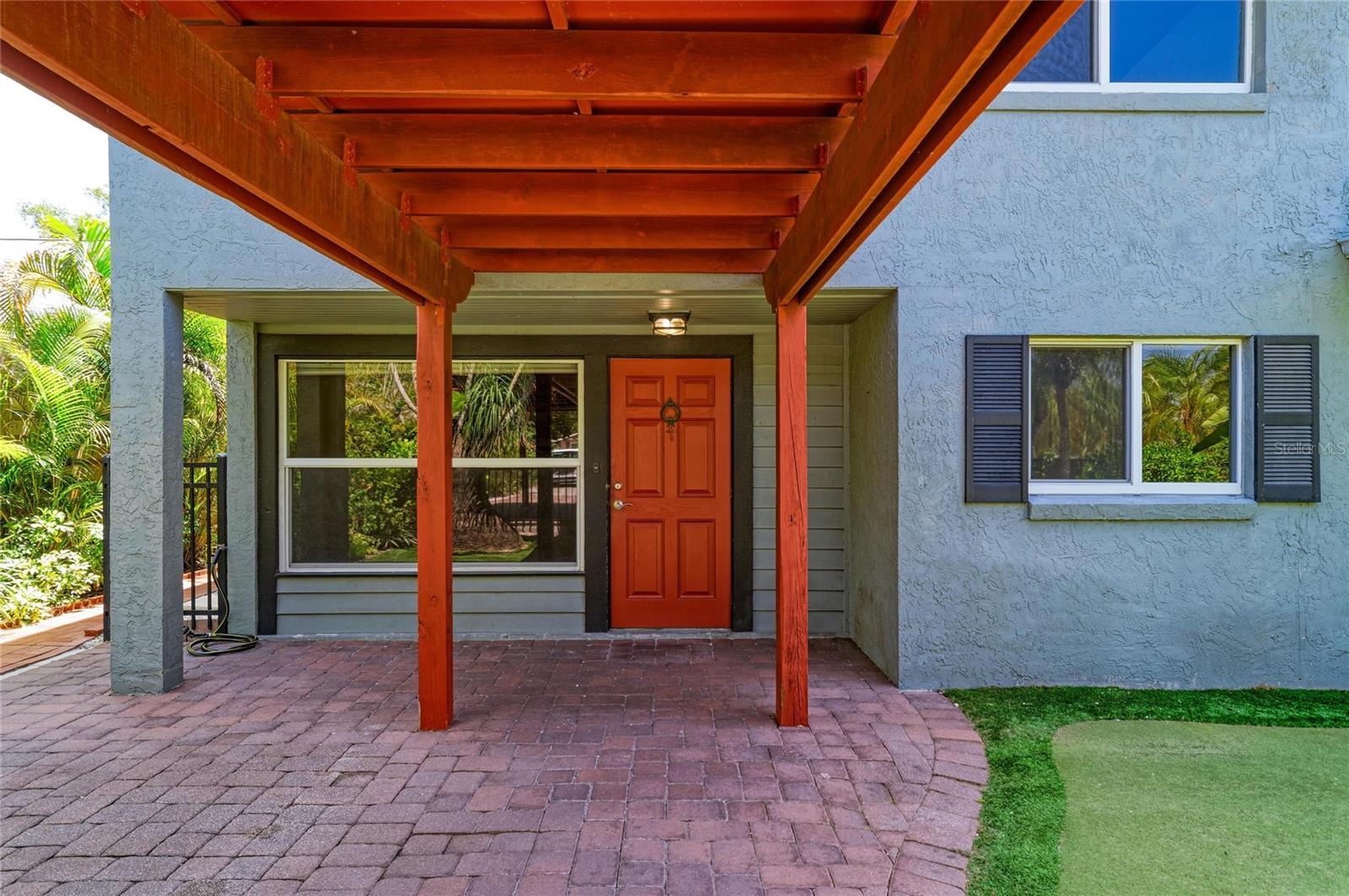 Unique and enchanting, this charming four-bedroom, two-bath split-plan home offers 2,190 square feet of character-filled living space. Vaulted ceilings with exposed wood beams, an ample-sized loft ideal for an office or guest space and a cozy wood-burning fireplace create a warm and inviting atmosphere. The thoughtfully designed layout and distinctive architectural details provide both comfort and versatility, ideal for everyday living and entertainment. The spacious primary suite features a large walk-in closet and added benefit of a newer separate air-conditioning unit (2023). The kitchen is well-appointed with granite countertops, wood cabinetry with over- and under-cabinet lighting and a convenient indoor laundry room nearby. The flexible fourth bedroom is positioned and generously sized to easily serve as a family room or dining area. Outside, enjoy a fully fenced backyard that feels like a private oasis, showcasing lush gardens in a peaceful, serene setting, ideal for attracting butterflies and native birds. Recent upgrades include a roof (2021), HVAC system (2019), water heater (2021) and PGT hurricane-rated windows and doors. Additional features include a putting green, a quiet dead-end street, a covered two-car carport with a breezeway, an outdoor storage shed, room for a pool and a large double driveway with plenty of space for RV or boat parking. Ideally located near downtown Sarasota’s fine dining and arts district, St. Armands Circle, UTC Mall, Interstate 75, Sarasota Memorial Hospital, parks, boat ramps, short distance to Riverview High School and Wilkinson Elementary School and the world-renowned Siesta Key and Lido beaches. This home offers a blend of charm, convenience and lifestyle.