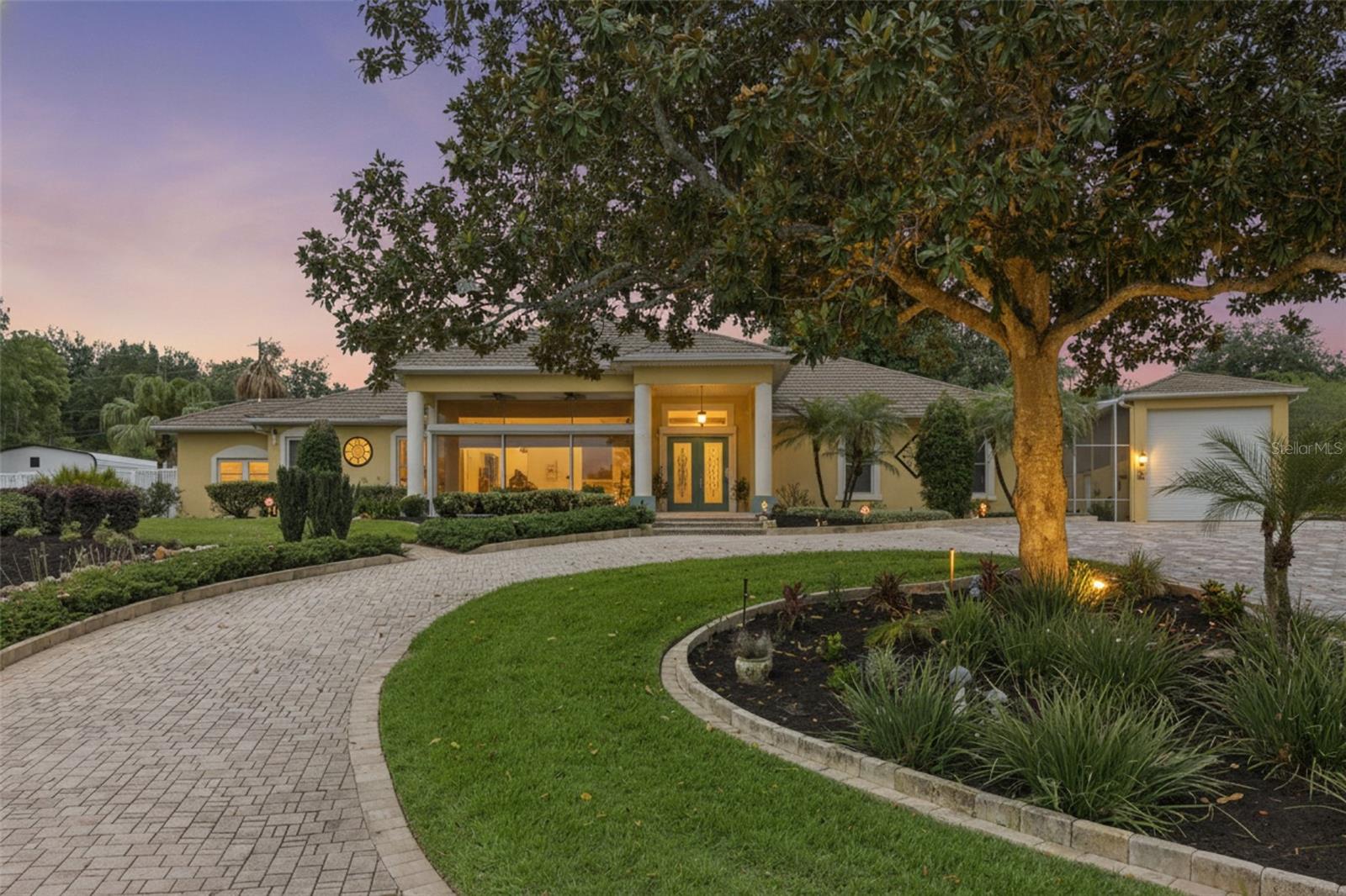 Are you ready to live the ultimate Florida lifestyle?  Do you enjoy watersports and spending time on the lake, or swimming in your own private pool, in between playing basketball & pickleball on your own court?  Well if you answered yes to any of those questions, 12128 Lakeshore Drive in Clermont is one home that you will not want to scroll past. Perched upon the iconic Lakeshore Drive in Clermont, this unique estate property offers more than one can imagine, and will check more boxes than you even knew you had.  Once you've walked up your 125' pavered driveway and are nearing the entry, you can really start to appreciate the exquisite views of Lake Minnehaha, and all that this home has to offer.  Across the threshold into the main home, you'll find floor to ceiling windows that set the backdrop for family get-togethers and holiday dinners, along with an abundance of natural light beaming in from every corner.  Two generously sized secondary bedrooms (each with their own en-suite bathrooms) are located on the west side of the home, while your new primary suite is located in the back of the home for extra privacy.  Not only does this primary bedroom have its own direct access to your private pool, but it also has two separate bathrooms, making it extremely convenient when starting the day.  An open kitchen with a SUB ZERO refrigerator, two sinks and granite countertops for as far as the eye can see make it even easier to be the go-to person for hosting.  The views from the kitchen are just as spectacular as the lake views, and your eyes are immediately drawn to the crystal blue pool and decadent waterfall feature behind it.  Need more space?  How about a second dwelling behind the main home, of which has been dubbed a "clubhouse". That's right, this is 1 of 5 homes in Clermont with a built-in bunker into the hillside, with it's own full bathroom, wrap-around bar and it's own separate HVAC unit.  This clubhouse would be the epitome of an entertainer's dream, and could double as a media room or even a formal guest home.  Adjacent to the pool is a fully insulated and commercial-sized RV Garage/Boat Garage with hurricane panels.  Beyond the clubhouse and multiple tiers of professional landscaping awaits a covered pavilion, where you can enjoy watching a game of basketball or pickleball, or even a morning cappuccino. > 160 FEET OF LAKE FRONTAGE ON LAKE MINNEHAHA | WHOLE HOME GENERATOR | SUMMER KITCHEN | NEW ROOF IN 2024 | HVAC IN MAIN HOME IN 2020 | NEW POOL PUMP & POOL RESURFACED WITH PEBBLE TEC IN 2021 | 125' FEET OF PAVERS ON DRIVEWAY | CUSTOM WATERFALL ON POOL DECK | NEW SEPTIC TANK & DRAINFIELD IN 2019 | WHOLE HOME WATER FILTRATION SYSTEM IN 2023 < Please see attached list of itemized updates.  Don't you deserve to finally live your best Florida life here?