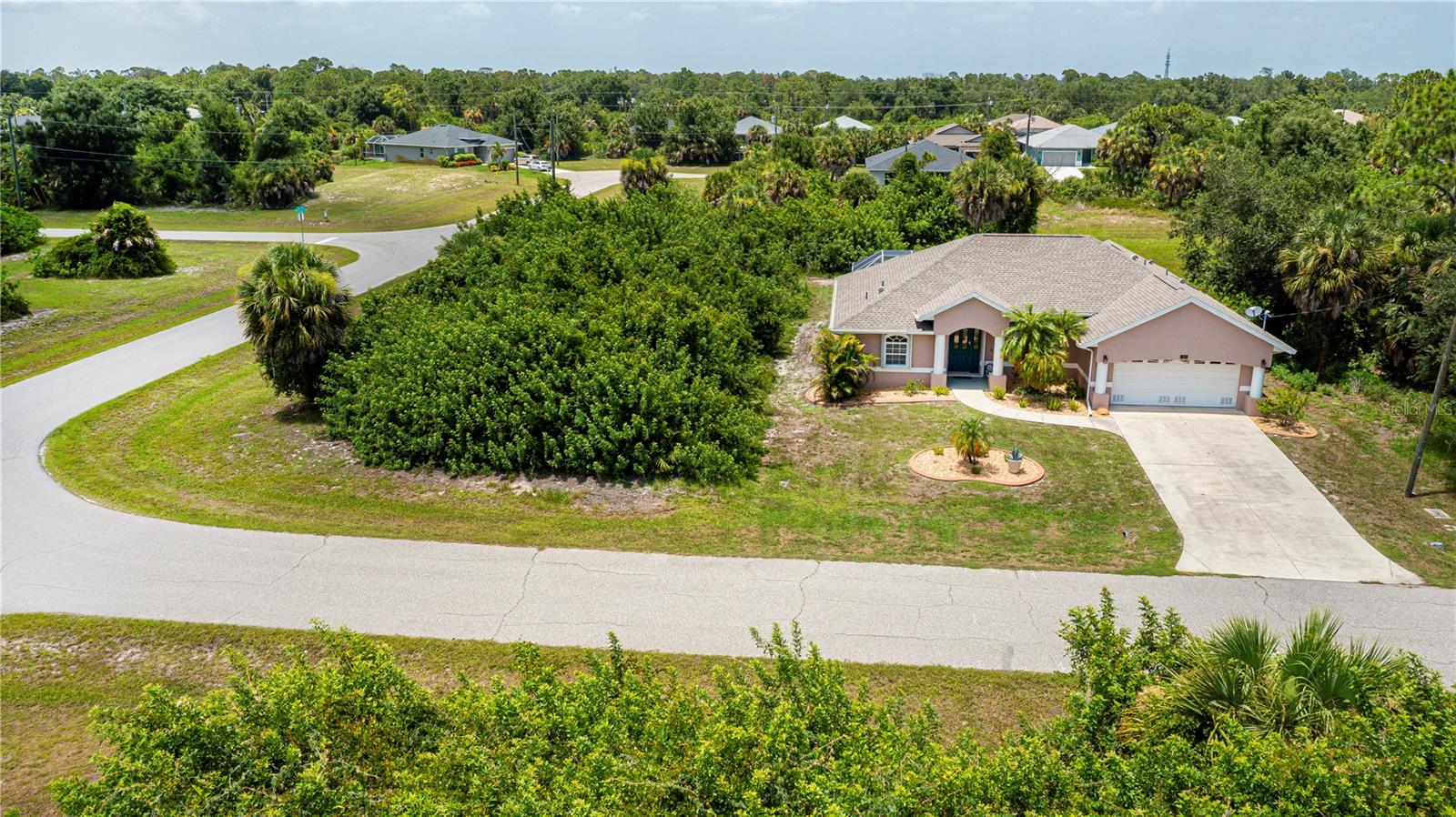 YOUR PRIVATE FLORIDA RETREAT JUST GOT EVEN BETTER WITH A BUILDABLE ADJACENT LOT INCLUDED and SOLD FURNISHED! Welcome to 113 & 121 Red Cedar Park in Rotonda West, where privacy, space, and Florida living come together on an impressive .41 ACRE PROPERTY with an additional buildable residential lot included in the sale. Tucked away on a quiet corner and surrounded by lush greenbelt views, this well-maintained 3-bedroom home offers the rare opportunity to enjoy extra elbow room today while preserving the option to build or invest in the future. Step inside to discover an inviting open floor plan highlighted by soaring vaulted ceilings, abundant natural light, and beautiful wood-look flooring throughout the main living areas. The spacious living and dining rooms flow seamlessly into the large kitchen featuring stainless steel appliances, extensive wraparound breakfast bar seating, generous counter space, and plenty of cabinetry, making it perfect for entertaining family and friends. The private primary suite offers tray ceilings, direct access to the lanai through sliding glass doors, a large ensuite bath with dual vanities, a tiled walk in shower, and plenty of natural light. Two additional bedrooms provide flexibility for guests or a home office as one has a Murphy bed , while the oversized laundry room offers exceptional storage and workspace. Step outside and enjoy true Florida outdoor living with the expansive covered lanai overlooking the screened HEATED POOL and the peaceful FENCED BACKYARD with SCENIC GREENBELT VIEWS. Whether you’re relaxing poolside, entertaining under cover, or enjoying the added privacy provided by the included lot, this property delivers an outdoor lifestyle that’s hard to find. Additional highlights include a NEW ROOF (DECEMBER 2022), NEW AIR CONDITIONING (2020), mature landscaping, a covered front entry with grand columns, and an oversized homesite that creates a private setting unlike most homes in the neighborhood. Conveniently located near parks, walking trails, golf courses, shopping, dining, and Gulf beaches, this home offers the ideal combination of comfort, flexibility, and long term value. DON’T MISS THIS RARE OPPORTUNITY TO OWN A HOME WITH AN INCLUDED BUILDABLE LOT, SCHEDULE YOUR PRIVATE SHOWING TODAY!