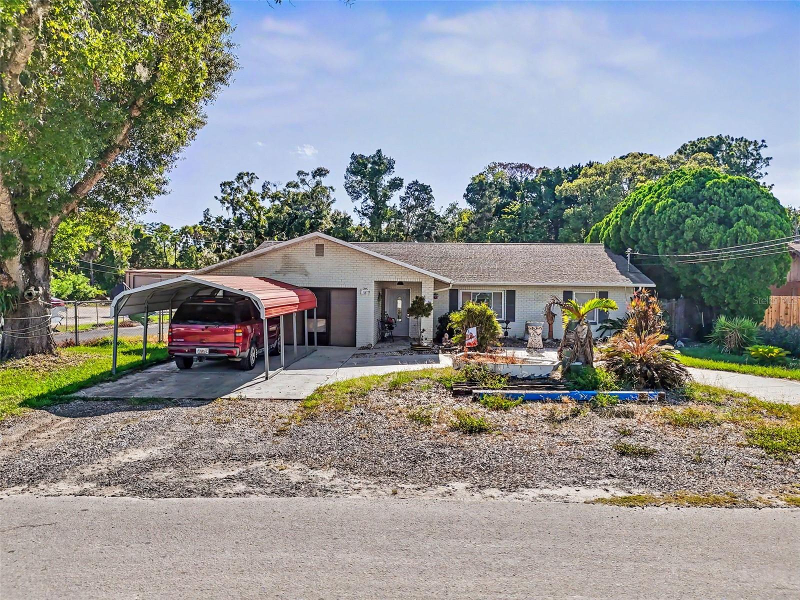 Great Live & Work opportunity in Port Richey FL.  Perfect for home-based business and live on site!!  Property is nearly 1/2 acre with an 1818 sf 3 bedroom 2 bath residence with attached 2 car garage, carport, fenced yard; 504 sf metal building with high ceilings, 2 overhead doors and AC'd office, 2 large metal carports, storage.  Residence is move in ready with recent remodel.  Beautiful Granite Kitchen with full appliance package, great bathrooms, roomy bedrooms, tile and laminate floors, central HVAC.  MOVE IN READY!
OR
C-3 Zoning allows property to be full commercial use and utilize residence as office or store/combo space.  Lots of potential, in great area of commercial use.