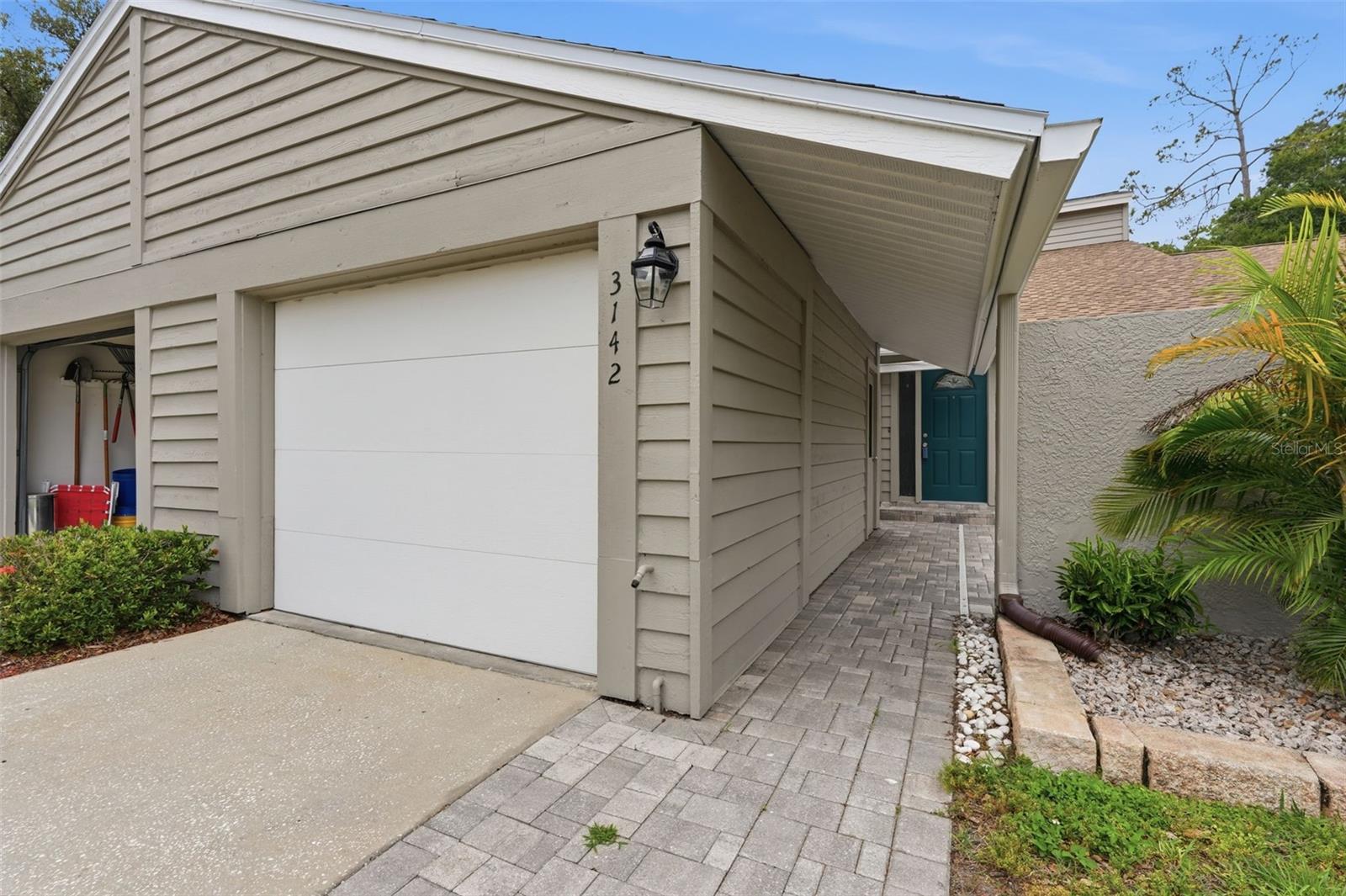 Welcome to Brooker Creek Villas, where maintenance-free living meets comfort and style. This beautifully updated 2-bedroom, 2-bathroom villa offers approximately 1,400 square feet of thoughtfully designed living space. Highlights include a 2017 A/C system, front patio area, detached garage, and storage shed for all your organizational needs. Step inside to discover a bright and inviting floor plan featuring an updated kitchen with custom cabinetry, abundant storage space, granite countertops, stainless steel appliances, and plenty of room for preparing meals and entertaining guests. The spacious living and dining areas flow seamlessly into the enclosed lanai, creating the perfect spot to relax and enjoy Florida living year-round. A unique spiral staircase leads to a versatile upstairs loft area that can easily serve as a home office, game room, reading nook, or additional sitting area. The spacious primary suite offers a large walk-in closet complete with custom organizers and a private ensuite bathroom featuring a dual-sink stone-top vanity and a glass-enclosed shower. The second bedroom and bathroom provide comfortable accommodations for guests or family members, while the in-unit laundry room adds everyday convenience.  The HOA provides exceptional value by covering exterior maintenance and roof care, while the monthly fee also includes cable TV, internet service, trash collection, access to the sparkling community pool, and more - allowing you to enjoy a truly carefree lifestyle. Ideally situated near John Chesnut Sr. Park, Lake Tarpon, multiple golf courses, popular dining destinations, shopping centers, and East Lake Road for convenient commuting. Plus, you'll be just a short drive from the beautiful Gulf beaches, making it easy to enjoy everything Florida's Gulf Coast has to offer. Schedule your showing today!
