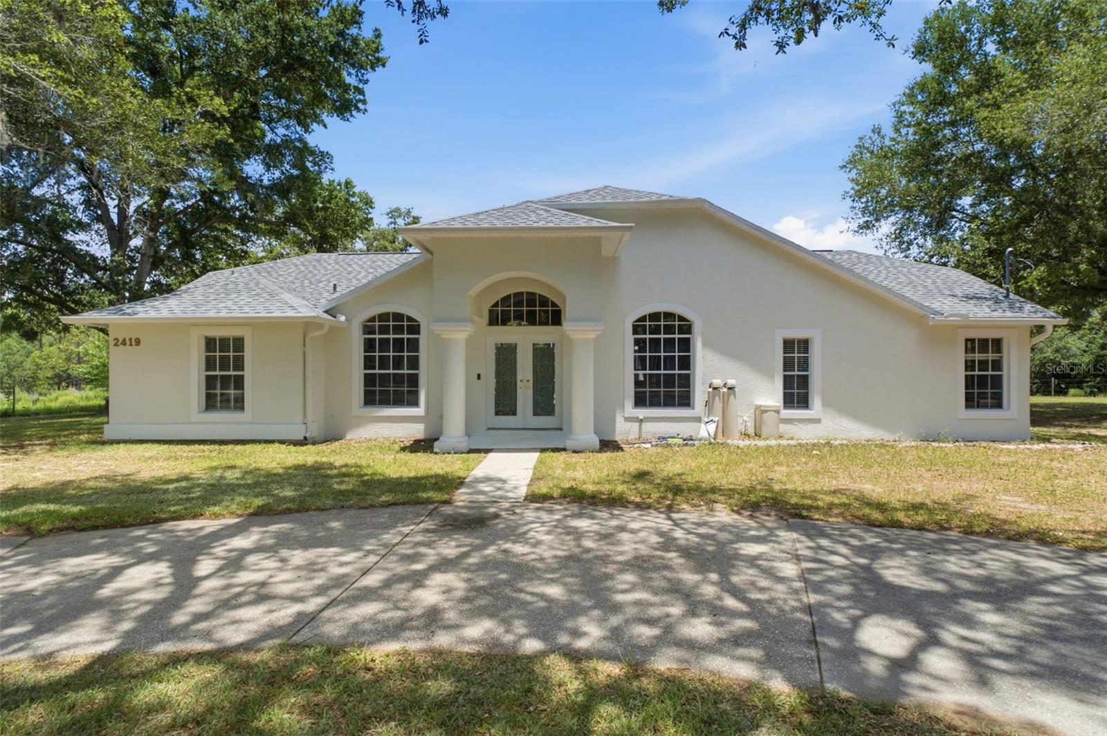 Nestled on 4.44 picturesque acres, this impressive 3-bedroom, 2-bathroom pool home offers the perfect blend of privacy, space, and versatility. Step inside to soaring high ceilings and an inviting layout designed for comfortable everyday living and entertaining alike.

The spacious primary suite serves as a private retreat, featuring dual walk-in closets, dual vanities, a relaxing soaking tub, and a separate walk-in shower. Sliding glass doors provide direct access to the pool area, creating a seamless transition between indoor and outdoor living.

Outside, enjoy Florida living at its finest with a sparkling screened pool overlooking the expansive property. The grounds offer endless possibilities with a large detached garage, multiple carports, and an RV hookup conveniently located in the backyard, providing ample space for vehicles, recreational equipment, hobbies, or storage.

Enjoy added peace and privacy with the Withlacoochee State Forest bordering the rear of the property, ensuring the land behind the home remains protected from future development and preserving the natural setting for years to come.

Recent updates include a 2025 roof and a 2022 water heater, offering added value and peace of mind. Adding even more potential, the neighboring property is also available for purchase, creating a rare opportunity for a family compound, multigenerational living arrangement, investment portfolio, or expanded private estate. With acreage, privacy, modern updates, and exceptional outdoor amenities, this property is a truly unique offering.