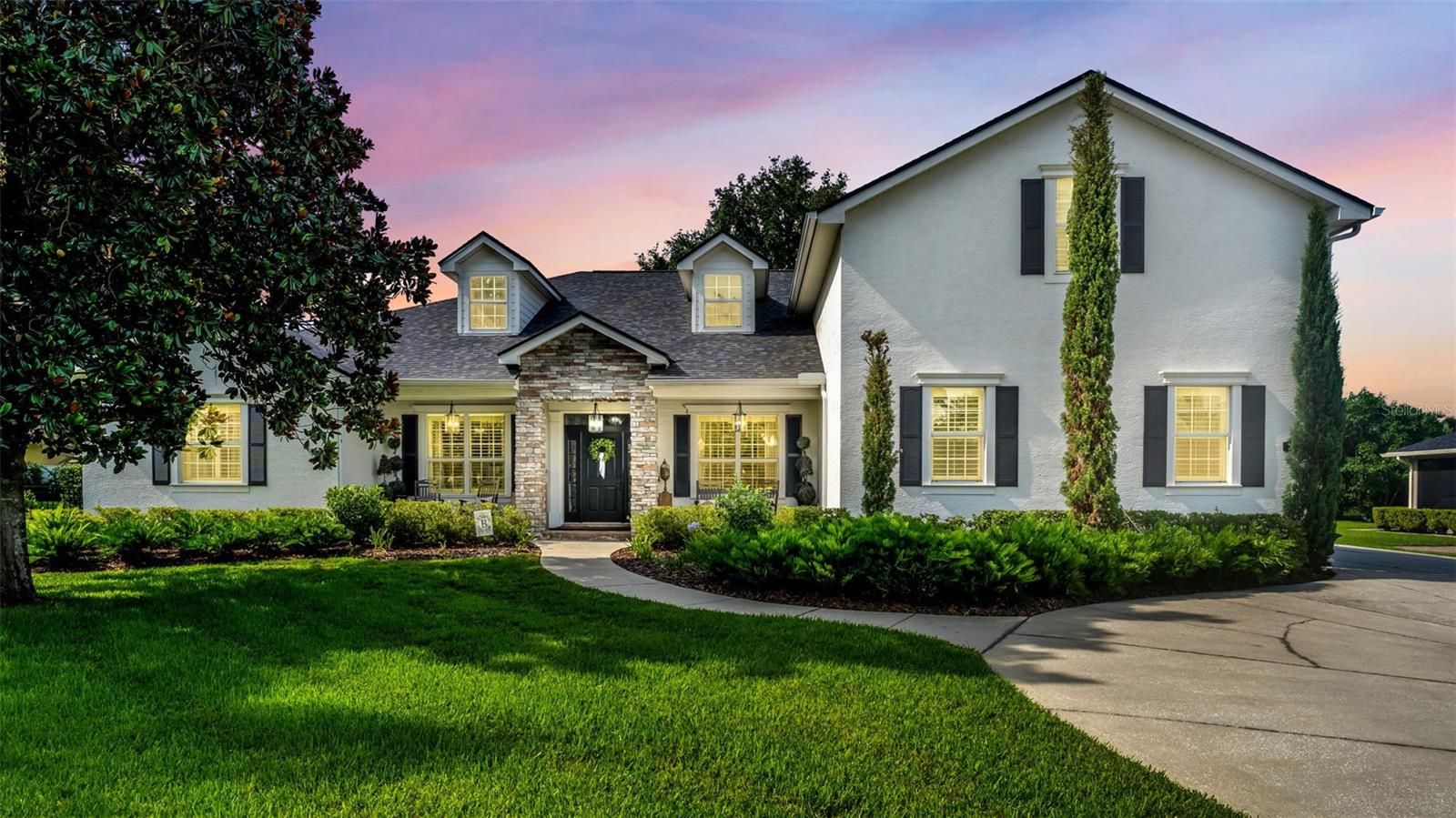 Where timeless elegance meets modern executive living, this exceptional home offers the perfect balance of sophistication, comfort, and a thoughtfully designed family-friendly layout. Situated on an expansive **half-acre homesite**, every detail has been carefully curated to create a home that is as functional as it is beautiful.

From the moment you enter, you'll be captivated by the abundance of natural light that fills the home, highlighting its elegant finishes and inviting atmosphere. Rich **crown molding**, **plantation shutters**, soaring ceilings, and tasteful designer touches create a warm yet refined space that feels equally suited for entertaining executives or enjoying everyday family life.

At the heart of the home is the stunning gourmet kitchen, designed for both the home chef and the entertainer. Featuring **double ovens**, generous workspace, abundant cabinetry, and an open flow into the living areas, it's the perfect gathering place for everything from holiday celebrations to weeknight dinners.

The intelligently designed **split floor plan** provides privacy for the primary suite while keeping family living comfortable and connected. A dedicated home office offers the ideal work-from-home environment, while the spacious **fifth bedroom upstairs** is currently utilized as a flex space and fitness room, offering endless possibilities as a media room, guest suite, playroom, or home gym.

Step outside and discover your own private backyard retreat. The spectacular **saltwater pool** is complemented by an incredible outdoor living space featuring a **built-in summer kitchen**, multiple covered entertaining areas, dual seating spaces, and a **large fire pit gathering area**—creating the perfect setting for everything from quiet evenings under the stars to unforgettable family celebrations and entertaining guests.

Beyond its beauty, this home offers complete peace of mind with a **new roof (2022)**, **two new HVAC systems (2022)**, and a **water softener (2022)**. Modern conveniences continue throughout with **app-controlled smart lighting** inside and out, an **EV charging station in the garage**, enhanced garage storage, and countless thoughtful upgrades that demonstrate the exceptional care invested in this home.

This is more than just a beautiful house—it's an executive-style residence that seamlessly combines luxury, elegance, and everyday livability. Every room has been designed with purpose, every upgrade selected with intention, and every detail considered to create a home that is truly move-in ready and unlike anything else on the market. If you've been searching for a home where refined elegance meets effortless family living, this extraordinary property delivers it all.