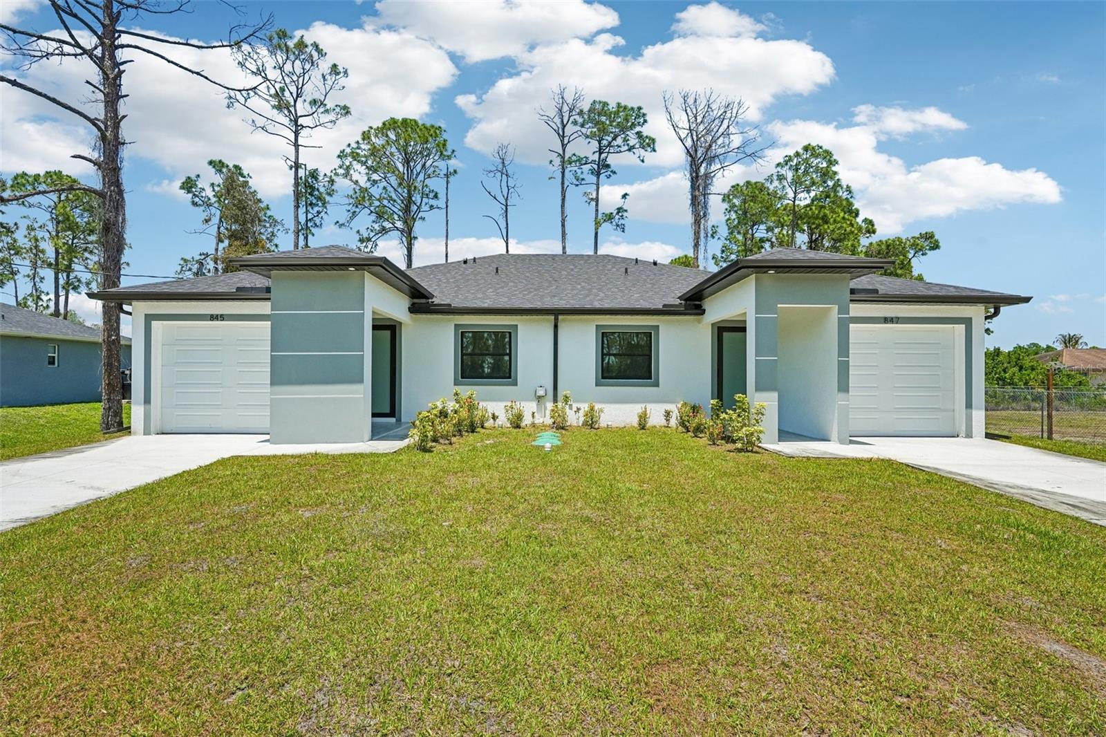 SELLER IS OFFERING INCENTIVES TOWARDS DOWNPAYMENT OR CLOSING COSTS. Positioned near the desirable Westminster pocket of Lehigh Acres, this newly built duplex WITH TWO ATTACHED GARAGE SPACES presents a compelling opportunity for investors seeking both stability and growth. With strong rental demand in the area, this property is well-suited for consistent income and long-term appreciation. Each side of the duplex offers a spacious 3-bedroom, 2-bathroom layout, complemented by its own attached 1-car garage with epoxy floor that adds everyday convenience and enhances tenant appeal. The interiors are designed with livability in mind, offering beautiful open-concept spaces and high end options. Modern construction meets elevated finishes throughout, including soaring 10-foot ceilings, 8-foot doors, quartz surfaces, and a full suite of upgraded appliances. Expansive living areas and abundant natural light create a clean, contemporary environment that stands out in the rental market. Built for efficiency as much as style, the property utilizes durable, low-maintenance materials that help to keep ownership costs down while supporting long-term performance. The location further strengthens its investment profile. Ideally positioned in Lehigh Acres with quick access to Fort Myers, this duplex is just minutes from the rapidly expanding corridor at SR 82 and Daniels Parkway, one of the area’s most exciting growth hubs. The upcoming Gateway Marketplace, anchored by Publix and Home Depot and slated for completion in 2027, along with the nearby Timber Creek community, is set to bring a surge of new retail, dining, and residential activity. Ongoing road improvements, including the widening of Daniels Parkway, further enhance accessibility and long-term value, making this an attractive opportunity in a high-growth location. For investors looking to secure a well-located, low-maintenance asset with immediate income potential and room to grow, this duplex checks all the boxes in one of Lehigh Acres’ most active rental corridors.