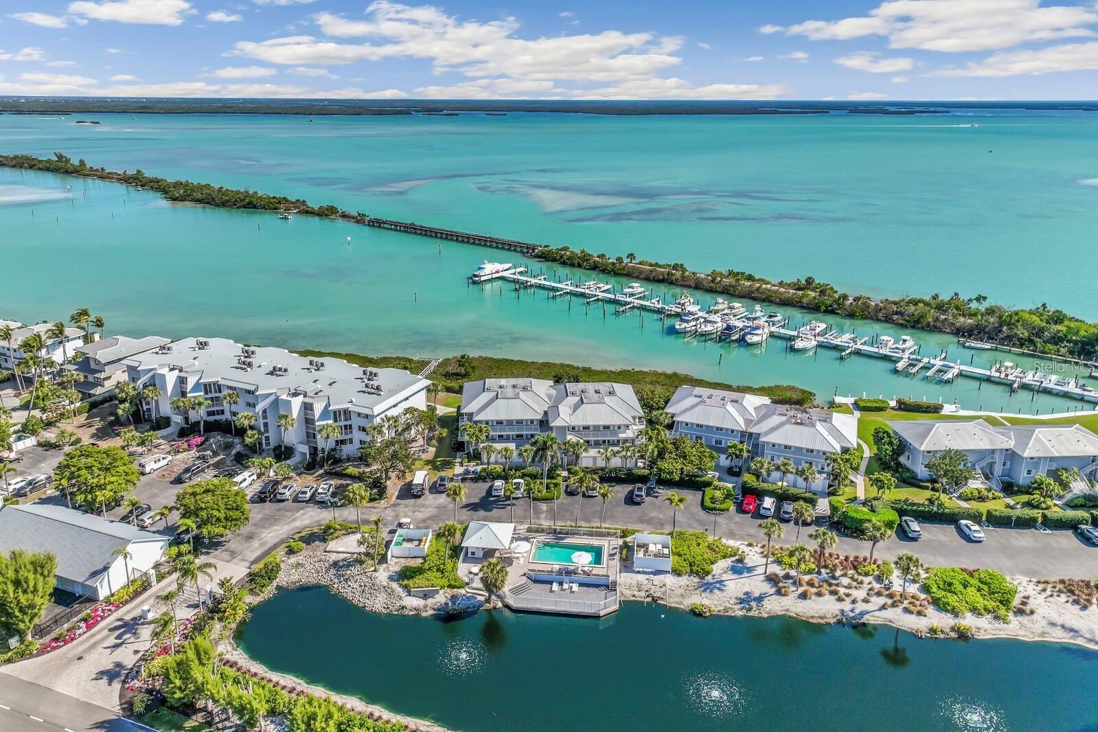 Under contract-accepting backup offers. Expansive marina and harbor views define this immaculate top-floor two-bedroom, two-bath residence at Marina Village. The open layout is designed to frame the water, allowing uninterrupted views to anchor the living spaces. Morning light fills the enclosed lanai, and in cooler weather the glass sliders can be opened to welcome gentle harbor breezes. The primary suite also enjoys peaceful water views. The residence is being offered furnished, presented in an elegant, neutral palette that feels both relaxed and refined. Additional conveniences include elevator access, ground-level storage, and modern safety features discreetly integrated throughout the building. Marina Village residents enjoy a private pool and sun deck, along with access to the Boca Grande Club’s amenities, including beachside dining, a beachfront pool with patio service and tiki bar, a recently updated fitness center, and one of the island’s most highly regarded tennis programs. Ownership also includes access to one of the largest and quietest stretches of beach on Boca Grande.