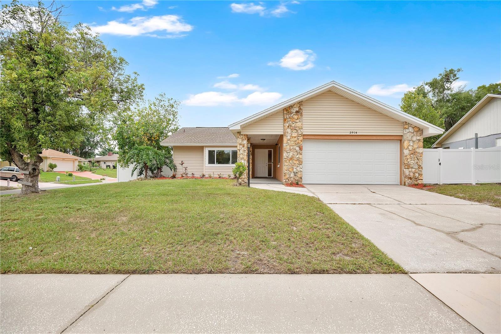 Looking for a move-in-ready 3-bedroom home in Orlando with a spacious Florida room, major system updates, and a large fenced backyard? Welcome to 3914 Foothills Drive in Magnolia Village, where modern updates, flexible living space, and pride of ownership come together in one exceptional home.

Offering 3 bedrooms, 2 bathrooms, 1,512 heated square feet, and an attached 2-car garage, this beautifully updated home sits on a generous 0.25-acre fenced lot and is ready for its next owner.

From the moment you arrive, you'll appreciate the attractive stone-accent exterior, inviting covered entry, and spacious front yard. Inside, the open floor plan is filled with natural light and features durable luxury vinyl plank and tile flooring, neutral designer colors, updated lighting, and a seamless flow between the living, dining, and kitchen areas, creating an ideal space for everyday living and entertaining.

The renovated kitchen features granite countertops, modern cabinetry, ample storage, and generous prep space, while both bathrooms have been tastefully updated with granite vanities, contemporary fixtures, and timeless finishes. The spacious primary suite offers a comfortable retreat, and two additional bedrooms provide flexibility for family, guests, or a home office.

One of this home's standout features is the expansive Florida room, fully air conditioned and included in the home's official square footage. This bright, versatile space extends the main living area and is perfect as a second family room, media room, game room, home office, fitness area, playroom, or simply a relaxing place to enjoy views of the backyard year-round.

Step outside to a generously sized, fully fenced backyard with plenty of room for pets, gardening, outdoor entertaining, or even a future pool. Mature landscaping creates a private setting while still offering plenty of open space to customize for your lifestyle.

Buy with ultimate peace of mind thanks to major system updates:

NEW ROOF: JULY 2018

NEW AC CONDENSER: 2019

NEW AIR HANDLER: 2018

NEW ENERGY-EFFICIENT WINDOWS: 2019

Conveniently located near shopping, dining, parks, schools, and major roadways, this home offers easy access to everything Orlando has to offer while providing the comfort of an established neighborhood.

Offered at $350,000.