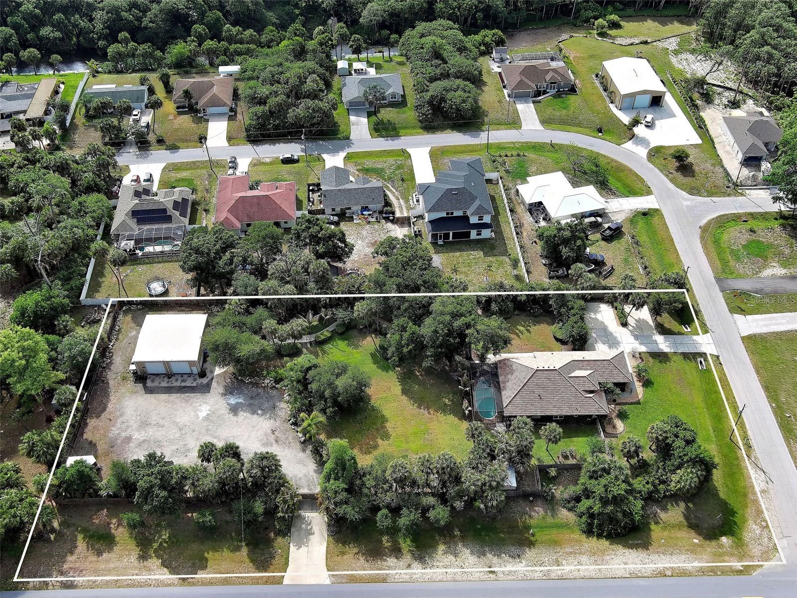 Welcome to your private slice of paradise at 3950 Pepper Lane in North Port, Florida. This beautifully maintained 3-bedroom, 2-bathroom home with bonus room that offers the perfect blend of comfort, space, and functionality—ideal for both everyday living and entertaining. Step inside to an inviting open floor plan that seamlessly connects the living, dining, and kitchen areas, creating an atmosphere perfect for hosting family and friends. Large sliding glass doors bring in natural light and showcase the surrounding landscape. Outdoors, you’ll find a heated pool ready for year-round enjoyment, all set within a meticulously landscaped 1.5-acre fenced lot that provides both beauty and privacy. The home has city water for the house, and well water for irrigation. Whether you're relaxing poolside or enjoying the expansive yard, this property offers a true Florida lifestyle. The home has extended driveway areas that provide plenty of parking. A standout feature is the impressive 40 x 40 insulated, air-conditioned, workshop with water and a lift, perfect for hobbyists, car enthusiasts, or business owners. With ample space for equipment, vehicles, or storage, this property is especially well-suited for operating a small business that needs lots of room for parking company vehicles. The shop has it's own entrance off of Salford Blvd. Recent improvements include, remodeled pool 2026, new pool pump 2026, new tile roof 2023, new hot water tank 2026, Well pump and pressure tank 2026, RV and generator electric connections. If you’re looking for a versatile property that combines residential comfort with business potential, this one checks all the boxes. Don’t miss this unique opportunity!