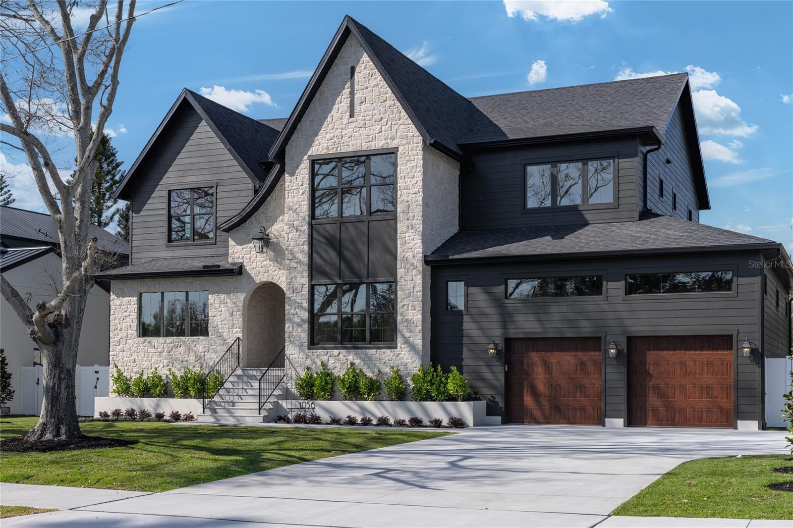Exquisite Modern Tudor Estate in Snell Isle.

     Welcome to 1056 Snell Isle Blvd NE, where timeless elegance meets modern luxury. This stunning custom-built home offers an unparalleled blend of sophistication, craftsmanship, and state-of-the-art design in one of St. Petersburg’s most coveted neighborhoods.

     Step inside to soaring 26-foot vaulted ceilings in the grand living room, accentuated by custom ceiling details, built-ins, and designer cabinetry throughout. With six spacious bedrooms and 5.5 beautifully appointed baths, this home is designed for both lavish entertaining and everyday comfort.

     The gourmet kitchen is a chef’s dream, featuring high end cabinetry, paneled appliances, large scullery and pantry, and a seamless flow to the expansive outdoor living space. Outside, enjoy Florida living at its finest with a custom pool and hot tub, a fully equipped outdoor kitchen, and a generous backyard—perfect for gatherings or quiet relaxation.

     Built to the highest standards of safety and efficiency, this home boasts impact-rated windows and doors, energy-efficient spray foam insulation, and compliance with all current hurricane codes. A spacious three-car garage completes this extraordinary property.

     Nestled in the prestigious Snell Isle community, this masterpiece offers both privacy and proximity to vibrant downtown St. Petersburg, world-class dining, and waterfront parks.



Experience a new level of luxury—schedule your private tour today.