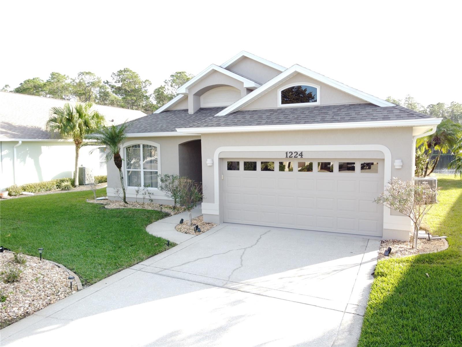 ***LAKEFRONT***GATED ***3 Beds X 2 Baths***LAWN CARE INCLUDED*** in Cypress Head Golf Community with community Pool & Tennis Courts. This home offers an open-concept that has huge living room opening through a sliding door to the Oversized screened-in Patio that is overlooking the magnificent views of the lake and the preserve. It has been freshly painted with very high Ceiling which boasts ample of natural light. The kitchen features Stainless steel appliances, light color cabinets with Granite countertops, crown molding and recessed lighting– all featuring Luxury vinyl and tile flooring with no carpets. The Owner's suite is situated for privacy with its private bath that has garden tub, walk-in shower, walk in closet. The other 2 bedrooms share a bath, and a laundry room is also located off the garage. The cypress head Golf subdivision is located in the top-rated schools’ zones, close to the beaches, golf courses, parks, shopping, and restaurants. It is all close by, where you can ride your bike to elementary, middle schools, a nearby public park and can easily get together with their friends for a game of basketball or tennis. This lot is high and dry and the home didn't get any water damage from the recent hurricanes.  All information and measurements in the MLS are intended to be accurate and approximate but cannot be guaranteed. Hurry up and book your showing today…WON’T LAST LONG!!!!