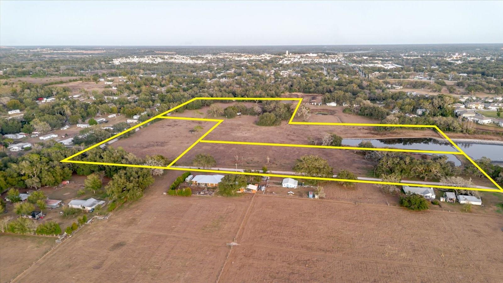 Assemblage opportunity consisting of three contiguous parcels totaling approximately 30± acres in one of Pasco County’s fastest-growing residential corridors. This prime development tract is strategically positioned immediately adjacent to Abbott Square, a recently delivered Lennar community, and within the broader Zephyrhills–Wesley Chapel growth belt that continues to attract large-scale residential investment and master-planned development. The surrounding area is experiencing sustained residential momentum, driven by expanding infrastructure, population growth, and the success of major lifestyle communities throughout Pasco County. Nearby master-planned developments such as Two Rivers, along with the nationally recognized MetroLagoon communities Mirada (San Antonio) and Epperson (Wesley Chapel), have reshaped the submarket by introducing resort-style amenities, strong absorption rates, and a new benchmark for lifestyle-oriented suburban living. These communities have proven the depth of housing demand in the area and continue to reinforce long-term developer confidence in the corridor.
This site is well-positioned for rezoning and entitlement efforts (subject to county approvals) to support a future Planned Unit Development (PUD) or other residential product types. The scale of the assemblage offers flexibility for a variety of development strategies, including single-family detached, townhomes, cottage-style product, or a mixed-density residential concept designed to meet evolving market demand. The property’s adjacency to existing residential development provides a strong planning and infrastructure narrative for entitlement discussions and future project feasibility.
Additionally, the property presents an optional pathway to participate in Pasco County’s “Villages of Pasadena Hills” (VOPH) planning framework. The seller has intentionally not pursued participation, preserving maximum flexibility and leaving all land planning and entitlement direction to the future buyer (subject to approvals and applicable process requirements). The location benefits from proximity to established and emerging communities, retail corridors, employment centers, and regional transportation routes connecting Zephyrhills, Wesley Chapel, San Antonio, and the greater Tampa Bay market.
As Pasco County continues to experience population inflows and outward residential expansion from Tampa and Hillsborough County, well-located development tracts of this size are becoming increasingly scarce. This offering presents a compelling value-add opportunity for builders, developers, and land investors seeking scale, optionality, and a clear path to creating value through rezoning, entitlement, and thoughtful product strategy. The combination of location, surrounding development activity, and long-term growth fundamentals positions this assemblage as a highly attractive candidate for future residential development in one of Tampa Bay’s most active and proven submarkets.
