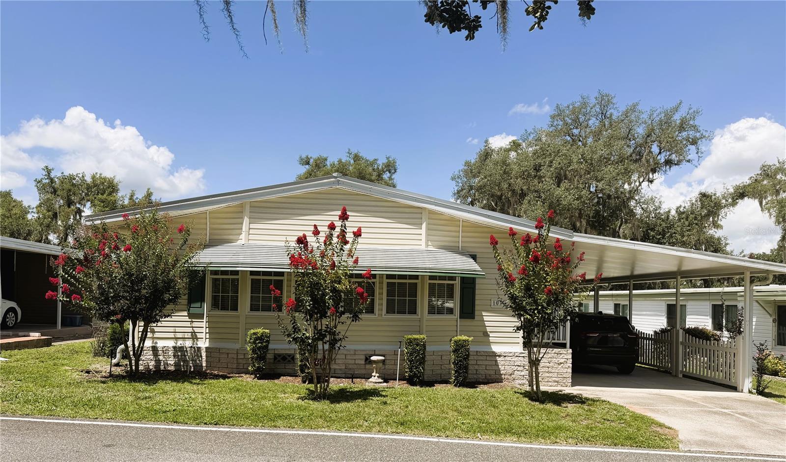 Welcome home to this beautifully maintained 2-bedroom, 2-bath home with a versatile study/den, built in 2001 and thoughtfully updated for comfort, style, and peace of mind. Major improvements include a new metal roof installed in 2023, replacing the original shingle roof, a new HVAC system and refrigerator in 2023, and a newly installed handicap lift in 2025, providing enhanced accessibility and convenience.

The spacious kitchen is both functional and inviting, featuring a newer oven and dishwasher, installed in 2016. The guest bathroom was tastefully remodeled in 2016 with attractive tile finishes and a modern glass-enclosed shower, replacing the original plastic enclosure. Every detail reflects the pride of ownership found throughout this lovingly cared-for home, making it truly move-in ready.
Located in the highly desirable Hawthorne at Leesburg, a vibrant resident-owned 55+ community, this home offers an exceptional lifestyle with an affordable monthly maintenance fee of just $397. Residents enjoy a maintenance-free lifestyle that includes water, sewer, lawn care, emergency services, and secure RV and boat storage.
The community's expansive clubhouse serves as the social center of Hawthorne, featuring over 100 organized activities, a hospitality lounge, card rooms, billiards, a fitness center, library, and fine arts studio. A dedicated program coordinator ensures there is always something exciting happening. Boating enthusiasts will appreciate the private marina with 120 boat slips and access to the beautiful Harris Chain of Lakes.
Safety and peace of mind are a priority with 24/7 on-site state-certified firefighter/EMTs, emergency vehicles, and in-home emergency response buttons. Residents also enjoy scenic walking trails, beautiful lake views, fishing, boating, and golf cart-friendly streets with convenient access to shopping, dining, and medical facilities.
Whether you're looking for an active social lifestyle, resort-style amenities, or simply a peaceful place to call home, Hawthorne at Leesburg offers it all.