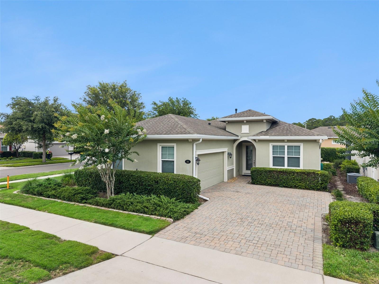 Come see this MOVE-IN READY Kolter Ivy with a 15’ x 28’ stone paver patio with privacy hedge that shows like a model within the 55+ Cresswind at Victoria Gardens neighborhood. This 3 Bedroom 2 Bath floorplan is LIGHT & BRIGHT and has a GREAT ROOM layout. Kitchen features 42” Dark Taupe wooden cabinets, tumble stone backsplash, Quartz countertops, breakfast bar w/ pendant lighting above, 5-burner natural gas convection range & stainless-steel appliances. Porcelain tile floors flow throughout entire home. DOUBLE PANE windows, crown molding, recessed lighting, ceiling fans & an expanded stone paver patio will add to the homeowner’s enjoyment. The 12’ x 17’6” primary bedroom has 2 walk-in closets & a bay window giving you a fantastic view to your private mature landscaped backyard. En suite bathroom offers dual raised height granite vanities, frameless glass enclosed WALK-IN shower w/ bench seat and a corner soaking tub. Utility room comes with the washer, electric dryer & a natural gas connection for a future use. The 22’ x 20’ garage w/ an epoxy floor finish has ceiling mounted storage racks for extra storage. All appliances stay with the home. Victoria Garden residents have access to their own Private Clubhouse. HOA fee includes lawn care, Spectrum HFC TV & internet and reclaimed water for yard irrigation. Community is within 1 mile of I-4 that offers great access to the east coast beaches, Orlando (40 minutes) and 3 International airports within 1 hour.