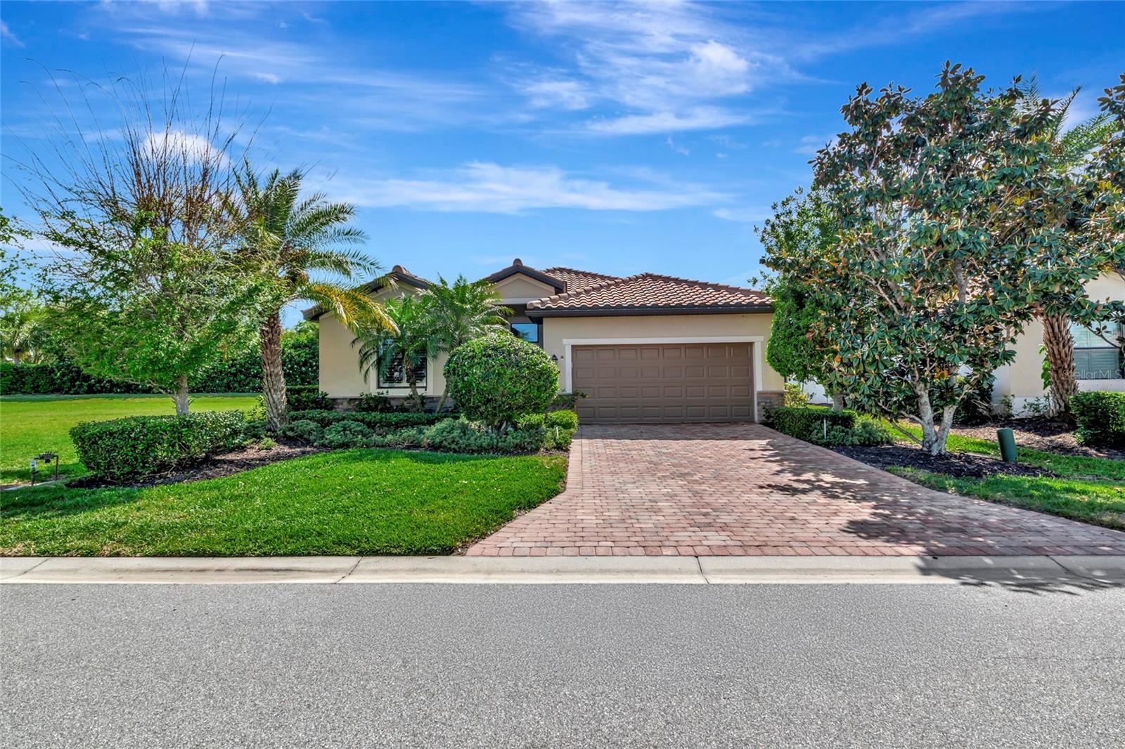 What if your next home came with ample space to live and a resort lifestyle right outside your door. This home in River Strand Golf and Country Club in Heritage Harbour deserves your attention.  The thoughtfully designed residence features an open floor plan ideal for entertaining.  The kitchen with custom woodwork and backsplash overlooks the dining and great rooms. A den with double doors is versatile and the perfect spot for a private office, study, or a flex room suit your needs. Hardwood floors add warmth to the main living areas and den.  Upgrades include added base and crown molding, newer carpet in bedrooms, custom closets in a guest bedroom and hall, a motorized sunshade, and a NEW AIR CONDITIONER installed in March 2026. Bedrooms are split offering true privacy. The primary bedroom comes with two walk-in closets and large bath with soaking tub, separate shower and private commode. Guest bedrooms have their own full baths, one with a walk-in shower with frameless glass doors. Set on a desirable lot with tranquil green space views, this home offers added privacy with no neighbors to one side and off the rear lanai. Beyond the home itself, the community delivers a true resort-style experience with amenities that appeal to a wide range of interests. Enjoy multiple pools, state-of-the-art fitness centers, pickleball and tennis courts, and a full calendar of social activities. Golf enthusiasts will appreciate the flexibility of pay-per-play access upon availability for Social Members offering the enjoyment of the game without full-time commitment and expense. Just completed is a multi-million dollar renovation of the Clubhouse, Dining Venues and outdoor Terrace. A 24-hour guard gated entrance with roving security adds to peace of mind. An urgent care center is within Heritage Harbour. Also within Heritage Harbour the Marketplace continues to expand. Costco, Target, Hobby Lobby, Aldi and multiple restaurants are in place with much more to come. A short drive away are I-75, Lakewood Ranch, University Town Center and those inviting Gulf beaches.