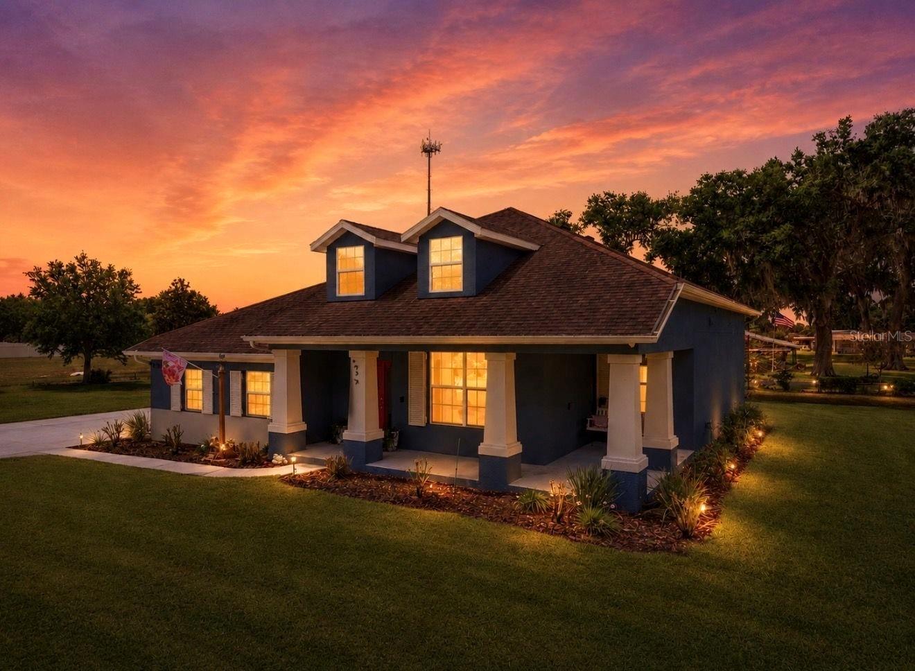 Some photos have been virtually enhanced.
This Amazing dream farmhouse style home with a large front porch sits on a spacious 1-acre lot in a picturesque, family-friendly community. This welcoming 4-bedroom, 2-bath home, 3 car garage is designed for both everyday living and entertaining, featuring luxurious tile floors throughout the living areas and wet zones, an open layout with tall ceilings, and upgraded lighting that enhances every room.

As you enter, you'll be greeted by a stunning wooden staircase and a large side office/den with beautifully adorned glass doors. The kitchen showcases white cabinets, granite countertops, a dark sink, stainless steel appliances, and a pantry closet, making meal prep a pleasure. The master suite and two additional bedrooms are located on the main level, all with brand-new carpet. The master features large windows, a spacious walk-in closet, a large walk-in shower, and dual sinks. The laundry room is conveniently adjacent to the master for easy daily use.

Upstairs offers a large bonus room perfect for movie nights, plus an additional bedroom with pre-plumbing for an additional bathroom, allowing you to add space or modify the layout at any time.

The outdoor space is a dream, offering an outdoor kitchen, large pergola and patio siting area, and endless possibilities for outdoor living! Tons of room to add a pool and you can easily fence for total privacy!

This property emphasizes energy efficiency with paid off solar panels, an EV charger, newer AC, Low-E windows, hurricane shutters, and a well for irrigation - all complemented by fresh interior paint throughout.

With tons of fruit trees like avocado, mango, pineapple and fig!

With a low HOA and No CDD!

Don't miss your chance to preview this beautiful home. Call today to schedule an appointment.