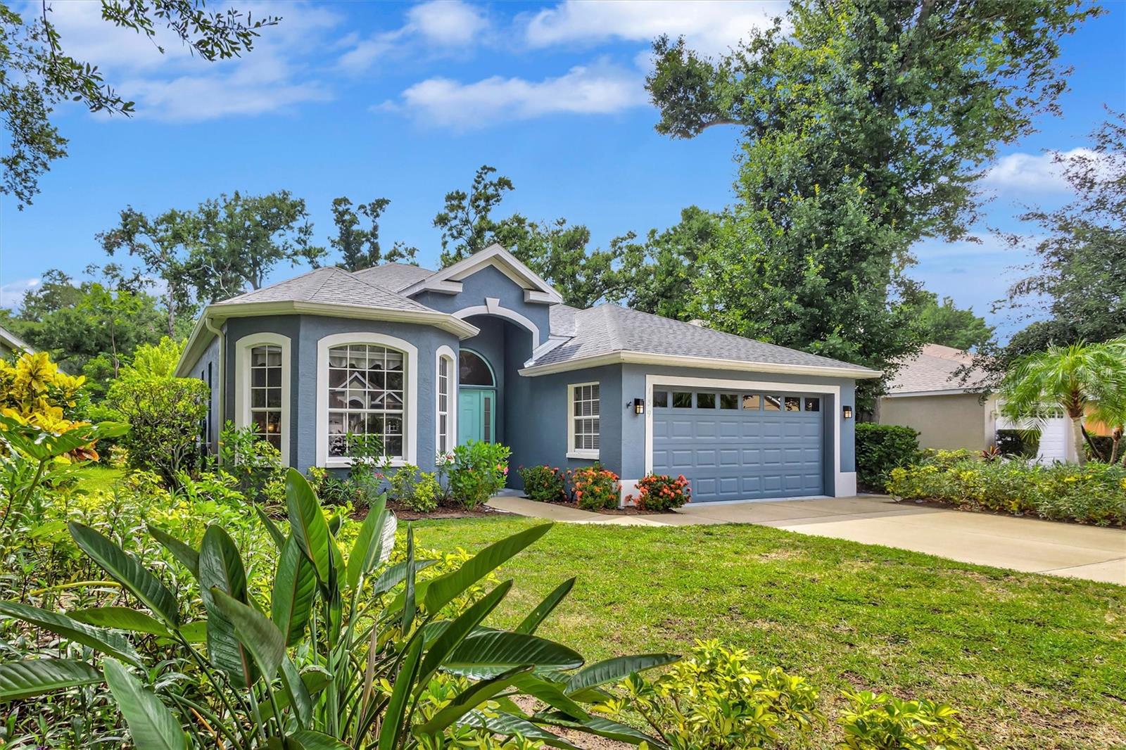 Behind the gates of Oak Court, this beautifully appointed three-bedroom, two-bath residence offers a rare combination of thoughtful design, quality craftsmanship, and modern convenience. Situated on a .17-acre homesite, the home enjoys a peaceful setting surrounded by mature trees and quiet streets, while remaining just minutes from downtown Sarasota, St. Armands Circle, and Sarasota's renowned Gulf beaches. Inside, soaring ceilings and porcelain plank flooring extending throughout the home create an open, light-filled atmosphere. Over $250,000 in carefully selected improvements and custom finishes have transformed the residence into a home of exceptional comfort and style. While custom remote-controlled shades and window treatments provide effortless privacy and ambiance. At the heart of the home is a stunning kitchen designed to balance beauty and functionality. An oversized quartz island serves as the centerpiece, surrounded by, designer hardware, and a striking glass, marble, and diamond-chip backsplash. The fully integrated smart appliance package includes a touch-control cooktop, double wall ovens, and an advanced smart refrigerator with voice capabilities, recipe assistance, shopping list functionality, music integration, and Wi-Fi connectivity. Throughout the home, custom designer lighting and upscale finishes create a warm and gracious atmosphere. The primary suite offers a relaxing retreat with quartz countertops, a freestanding soaking tub, and a spacious walk-in shower featuring opalescent tile and distinctive wave-pattern walls. The guest bath is equally impressive, highlighted by a custom marble vanity. Outside, the paver lanai extends the living space, providing a comfortable setting for entertaining or simply enjoying Sarasota's year-round sunshine. Every element of the home reflects pride of ownership and a commitment to quality, combining timeless finishes with modern technology in a residence that is both elegant and exceptionally livable. Surrounded by mature canopy trees and peaceful streets, yet conveniently located near downtown Sarasota, St. Armands Circle, and the area's world-class beaches, 139 Tall Trees Court represents an exceptional opportunity to enjoy refined living in one of Sarasota's most desirable settings.