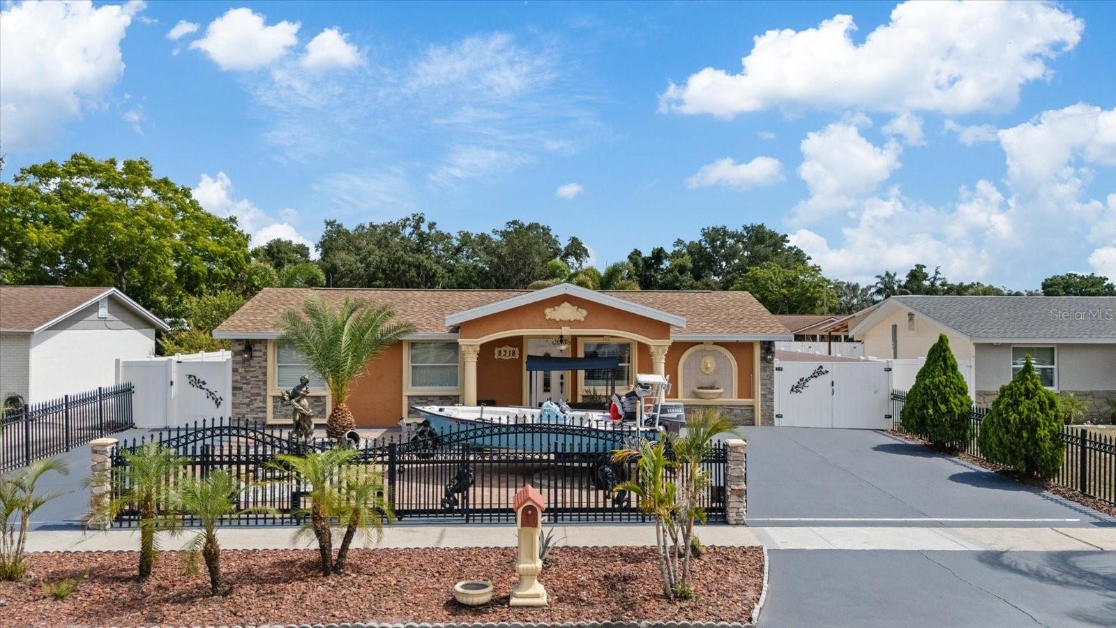 Move-in ready and ideally located in Tampa, this beautifully maintained home is situated in an area where flood insurance is not currently required and features a brand-new roof installed in February 2026. Conveniently located near major highways, shopping, restaurants, grocery stores, and everyday conveniences, it offers the perfect balance of comfort and accessibility. From the moment you arrive, you'll appreciate the home's curb appeal, quality craftsmanship, and attention to detail.
The main residence offers 3 bedrooms and 3 full bathrooms, along with an oversized kitchen featuring premium cabinetry, abundant storage, and plenty of space for everyday living and entertaining.
A fully permitted detached one-bedroom, one-bath guest house adds exceptional flexibility. According to the seller, the guest house is currently rented on a month-to-month basis for $1,000 per month, offering an excellent opportunity for supplemental income, multigenerational living, private guest accommodations, or a home office.
Designed for those who love to entertain, the covered outdoor kitchen is one of the home's most impressive features. Beautifully finished with quality materials and thoughtfully designed, it provides the perfect setting for outdoor cooking, dining, and gathering with family and friends while enjoying Florida living year-round. Additional highlights include a motorized wrought-iron entrance gate with remote access, dual driveways, a charming front fountain, and quality finishes throughout. Combining comfort, functionality, income potential, and an unbeatable location, this exceptional property is ready to welcome its next owners.