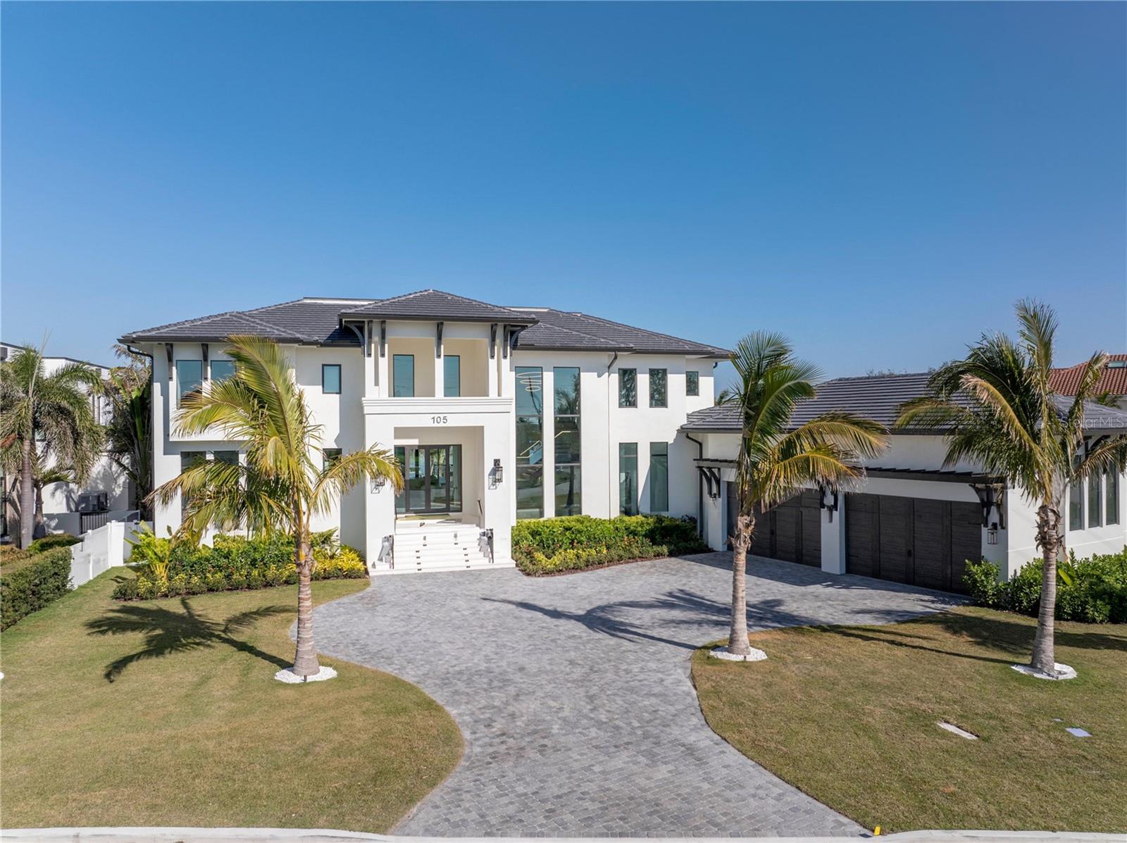 **100% Complete & Move In Ready** As Good As It Gets!  This Single Family Residence in Snell Isle by the Renowned Hughes Construction Team is the Epitome of Luxury, and Offers the Florida Lifestyle at its Finest!  Resting on an Oversized (0.51 Acre), Protected Waterfront Lot on Snell Isle Harbour, This All Concrete Block Construction Home is Built to the Highest Standards of the Florida Building Code, and Captures Beautiful Water Views from Nearly Every Room.  Offering Five (5) Bedrooms + Lounge + Office, Six and One-Half (6.5) Bathrooms, Four (4) Car Garage with Soaring Ceilings, Custom Pool & Spa with Infinity Edge & Fire Bowl Features, Boat Dock with Lift and a Private Beach & Outdoor Shower Tower.  Extensive List of Features Include the Following: Subzero, Wolf & Alfresco Appliances, Outdoor Kitchen, Luxury Wood Cabinets with Marble, Quartz & Quartzite Countertops, Metal Double Door Front Entry, Aluminum & Vinyl Fencing, Engineered Hardwood Floors with Marble & Porcelain Tile in Bathrooms, 8" Baseboards, Tongue & Groove Ceilings in Selects Rooms, High Impact 10' x 8' Garage Doors with High Lift, Natural Gas for Tankless Water Heater,  Pool Heater & Select Appliances, Level 5 Smooth Finish Drywall, Emtek Door Hardware, 11' 4" Ceilings on Main Level and Vaulted Ceilings in the Owner's Suite & Bonus Room (5th Bedroom), 8' Solid Core Interior Doors, Sound Insulation in Owner's Suite, Glass & Cable Railings, Tropical Landscaping with Coconut Palms & Banana Trees, Outdoor Lighting, Concrete Tile Roof, Steel Construction Floating Staircase with Oak Clad Stairs, Floor to Ceiling Windows on Lower Level and So Much More.  The Owner's Suite is a True Retreat, Offering a Spacious Bedroom with Vaulted Ceilings, Private Balcony, Two Walk-In Closets with Custom Organization Systems and a Royal Bathroom with Free-Standing Tub, Large Walk-In Shower and Beautiful Cabinetry.  Elegant Coastal Aesthetic with Motor Court and Expansive Front Yard Makes this a True Estate Home.  Move In Right Away and Rest Easy on the Private Beach Overlooking Snell Isle Harbour with Gentle Breezes Off of Tampa Bay!