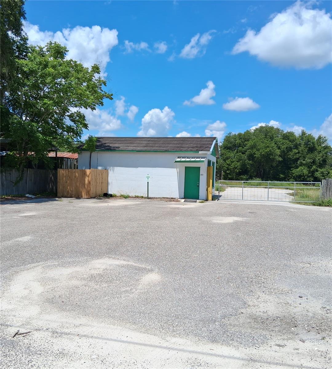 This 4 1/2 acres fronts 2 paved roads. Well & Septic in place, electric. Currently has an office building on property with a lobby area, storage room & an office in the back, 2 old pole barns (up to the buyer as their valued use).  the county says :Zoning in place is RR5C. County says possibility of having it annexed in to the City of Webster, get Rural Res FLU, and then rezone to City RR1C to get four 1+ acre parcels out of that, if the goal is to split it.