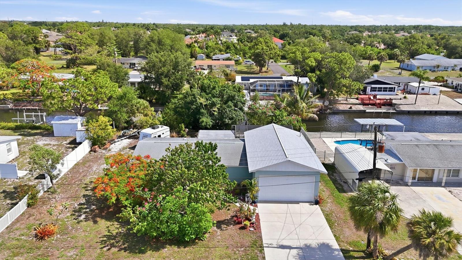 Live the ultimate Florida WATERFRONT lifestyle at this beautifully maintained CANAL-FRONT POOL HOME in the heart of Englewood! Offering QUICK GULF ACCESS right from your backyard, this property is a dream for boating enthusiasts and anyone looking to enjoy the very best of coastal living. From the moment you arrive, you’re greeted by lush tropical landscaping and a stunning mature mango tree that creates a warm and inviting first impression.

Situated on an oversized lot, this spacious residence features 3 bedrooms, 2 bathrooms, a dedicated office/den, and a comfortable layout designed for both everyday living and entertaining. The well-appointed kitchen offers abundant cabinetry, convenient slide-out drawers, and newer appliances including the refrigerator, stove, microwave, dishwasher, washer, and dryer. A dedicated indoor laundry room adds everyday convenience, while the beautifully updated primary bathroom features a walk-in shower. Recent major upgrades including a NEW ROOF over garage in 2024 and AC in 2022 provide added peace of mind.

Step outside and experience your own private waterfront retreat. The recently resurfaced pool creates the perfect setting to relax after a day on the water, while the outdoor shower adds to the true Florida lifestyle feel. The private dock and covered boat lift make getting out to Lemon Bay, the Intracoastal Waterway, and the Gulf quick and effortless. Bring your boat, golf cart, jet skis, and all the toys — this property was designed for it all with exceptional storage throughout and an OVERSIZED GARAGE featuring soaring ceilings, room for larger vehicles, workshop space, and all your boating and fishing gear. The mature tropical landscaping and fruit trees surrounding the property make this home feel like a true oasis.

Conveniently located right in the center of town, you’re just minutes from Manasota Key, Boca Grande, local beaches, restaurants, shopping, grocery stores, schools, and live entertainment. Whether you’re looking for a full-time residence, seasonal getaway, or your own slice of waterfront paradise, this property truly captures everything people love about Southwest Florida living.