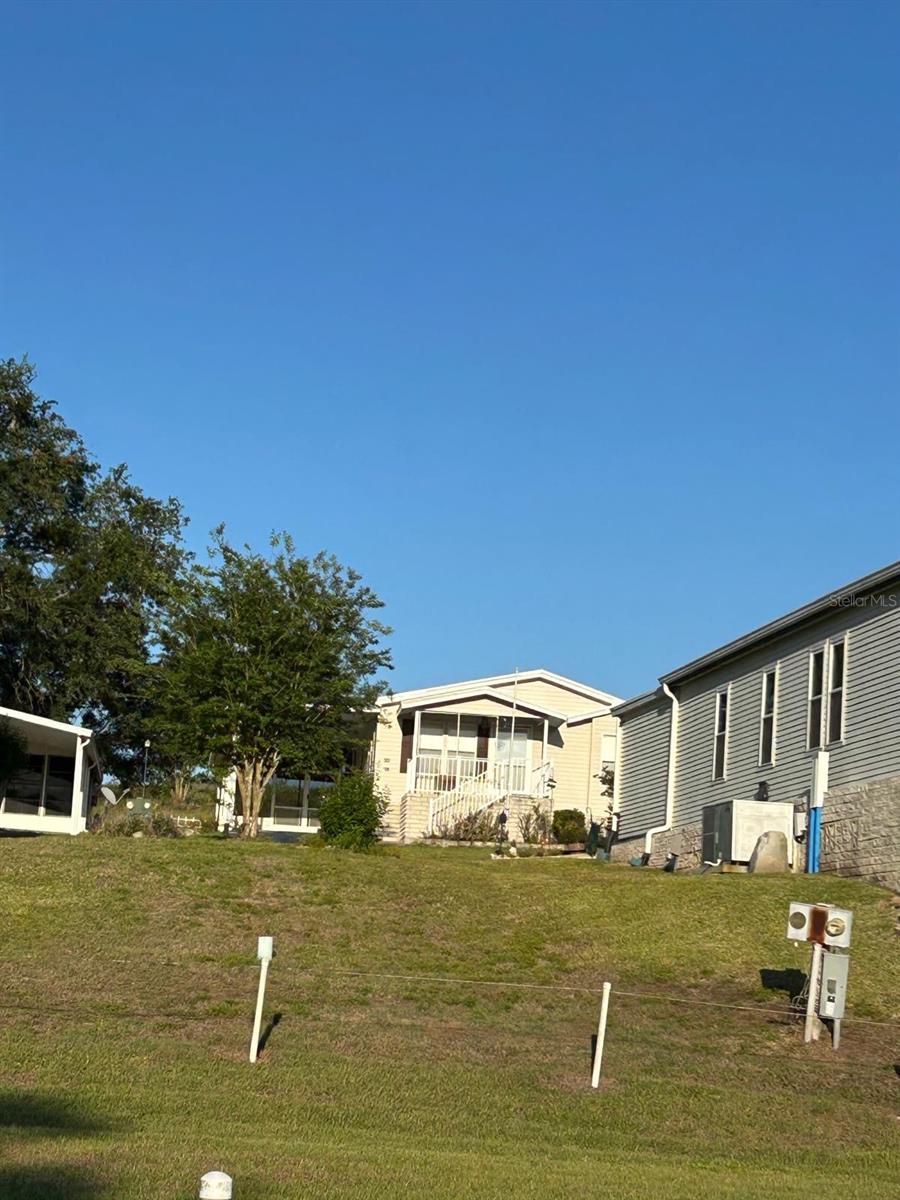 Rare opportunity to custom-build your Florida retirement on this beautifully elevated, 0.11-acre lot in the highly sought-after 55+ community of Twin Fountains. Positioned with no rear neighbors, this homesite offers a level of privacy and a natural breeze that is hard to find. Whether you’re looking to place a brand-new manufactured home or a gently used model (up to 3 years old), this lot is perfectly prepped and ready for a single or double-wide layout. Enjoy a low-maintenance lifestyle where your $180/month HOA covers lawn care, cable, internet, water, and sewer. Spend your days at the heated community pool or exploring the central Florida coastlines—both just 90 minutes away. Owner financing is available, making it easier than ever to secure your piece of paradise.