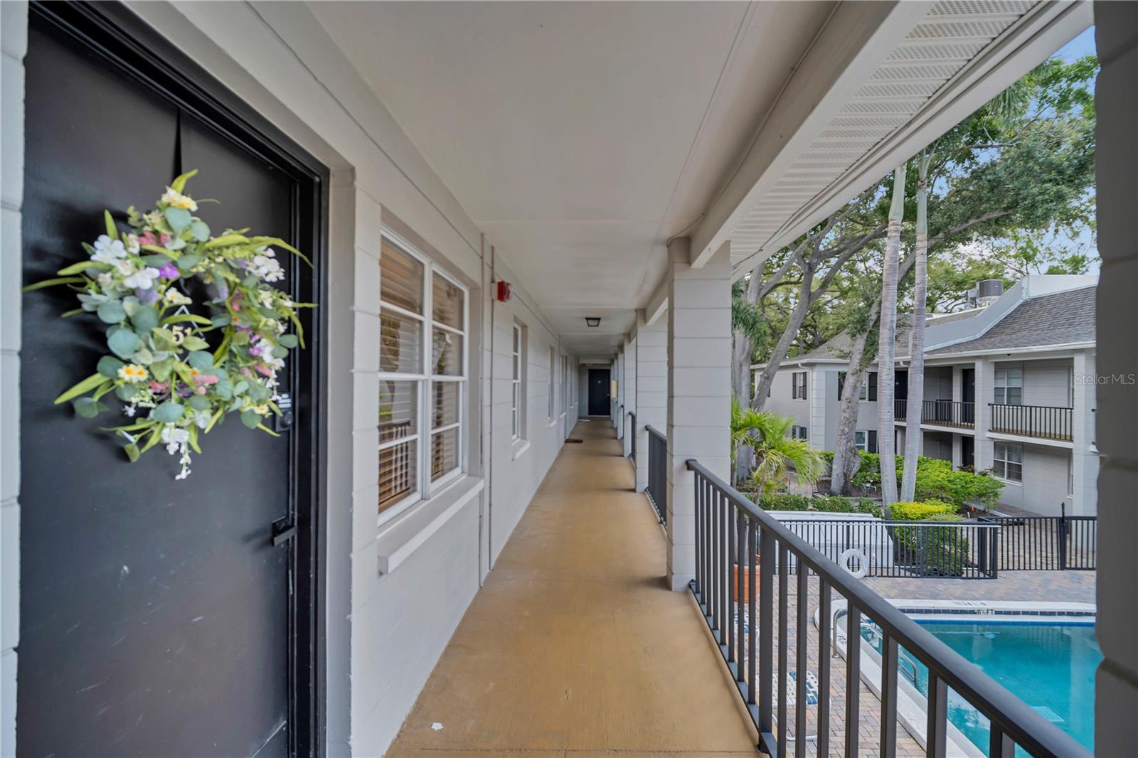 Virtually Staged. Welcome to Bayshore Landings, a well-maintained condominium community just steps from iconic Bayshore Boulevard. This rare second-floor, pool facing 1-bedroom, 1-bath residence offers approximately 644 square feet of comfortable living space with abundant natural light and a functional layout.  The spacious living and dining area flows into a well-appointed kitchen featuring ample cabinetry, granite countertops, a designer backsplash, stainless steel appliances, and an oversized pantry for exceptional storage. Recent updates include modern ceiling fans, a lighted bathroom mirror, battery-operated under-cabinet lighting and updated cabinet hardware.  Residents enjoy a community swimming pool, beautifully maintained grounds, and convenient on-site laundry facilities. The low monthly HOA fee—lower than many Tampa-area condominium communities—includes water, sewer, trash, exterior maintenance, roof maintenance, and common area upkeep. The community also features a new roof and fresh exterior paint completed in 2024.  Conveniently located near Hyde Park, Downtown Tampa, and MacDill Air Force Base, you'll enjoy easy access to shopping, dining, entertainment, and the scenic waterfront along Bayshore Boulevard. Whether you're a first-time homebuyer, investor, or seeking a low maintenance South Tampa lifestyle, this move-in-ready condo is an exceptional opportunity. Pet-friendly for owners, while rental occupants may have approved service animals or emotional support animals in accordance with applicable regulations.