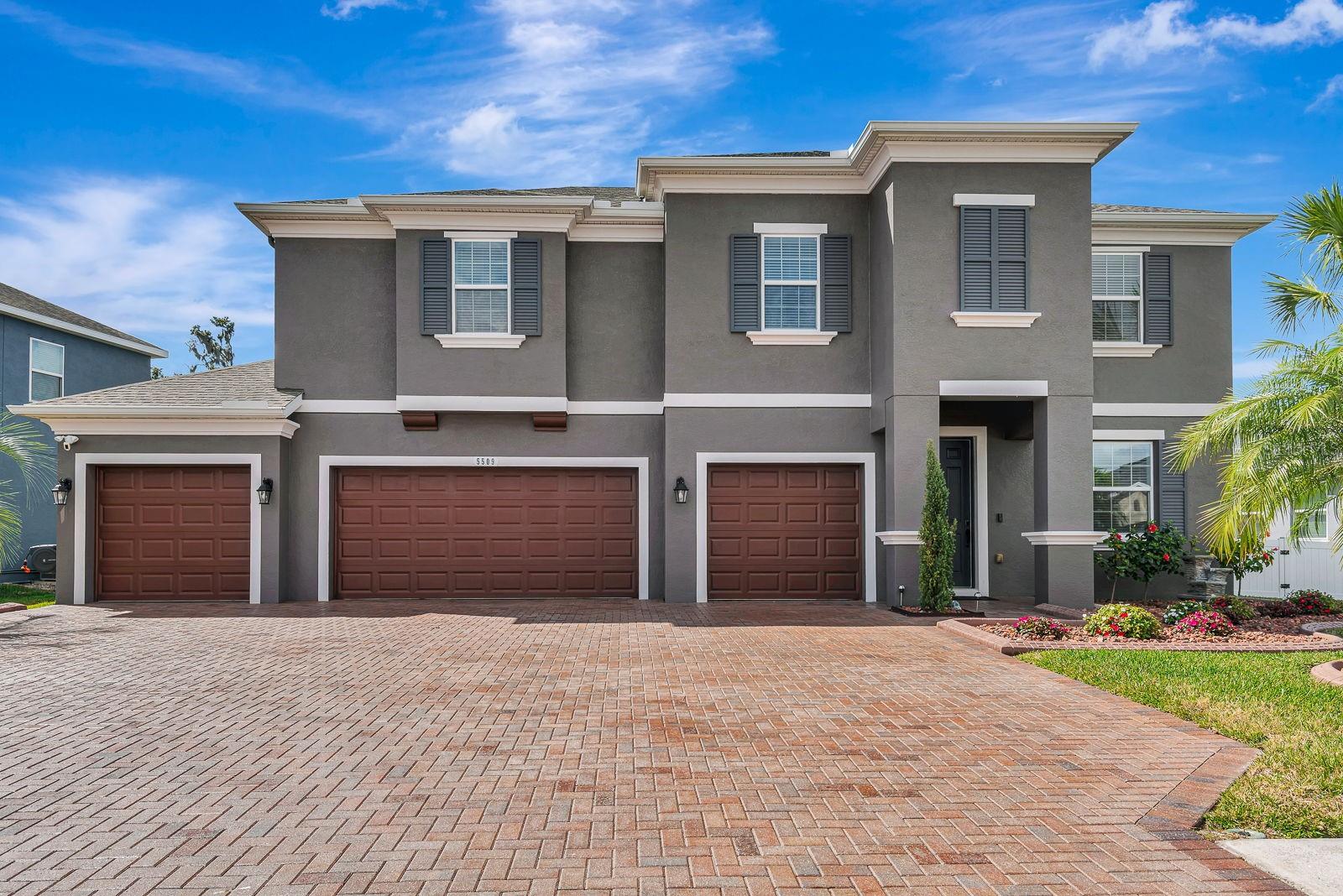 Experience luxurious living in the gated community of Oakleaf Hammock with this tastefully designed 2017 home offering over 3,500 sq ft of living space and a full 4-car garage. This 5-bedroom, 3.5-bath home also features a private office, an upstairs loft, and an oversized bonus room, providing incredible flexibility for work, play, and guests. Step inside to an open-concept living, dining, and kitchen area highlighted by porcelain wood-look tile, crown molding, and soaring ceilings that create a bright, welcoming feel. The dream kitchen boasts 42" custom cabinets, granite countertops, tile backsplash, stainless steel appliances, an electric cooktop with vent hood, a built-in wall oven and microwave, a top-of-the-line 4-door refrigerator, and a convenient closet pantry. A large breakfast bar flows into the dining and living spaces with surround sound and double sliders leading to the covered porch, perfect for entertaining. The first-floor primary suite offers a true retreat with a spa-like ensuite featuring a granite double-sink vanity, huge seamless glass walk-in shower with dual shower heads, and a generous walk-in closet. Also on the main level are a French-door office/flex room, a half bath with a linen closet, and a laundry room. Upstairs, a spacious loft plus an oversized bonus room provide additional living space ideal for a media room, game room, or second office. Two 12x12 bedrooms share a Jack-and-Jill bath witha  granite vanity, while two more bedrooms share a third full bath. Outside, you'll find an oversized paver driveway, professional landscaping, and an exterior Ring camera system. The covered back porch overlooks the luxurious POOL with Screened Lanai! This home offers easy access to I-75, making commutes to Tampa, St. Petersburg, Sarasota, and the growing Palmetto and Parrish areas a breeze. Just minutes from Ellenton Premium Outlets, top-rated schools, shopping, dining, and medical facilities, this home is also a short drive to University Town Center Mall, St. Armands Circle, Selby Botanical Gardens, the Ringling Museum, and Florida's breathtaking Gulf beaches. Homes with this much space, privacy, and natural beauty are a rare find! Don't wait -schedule your showing today and make this exceptional home yours!