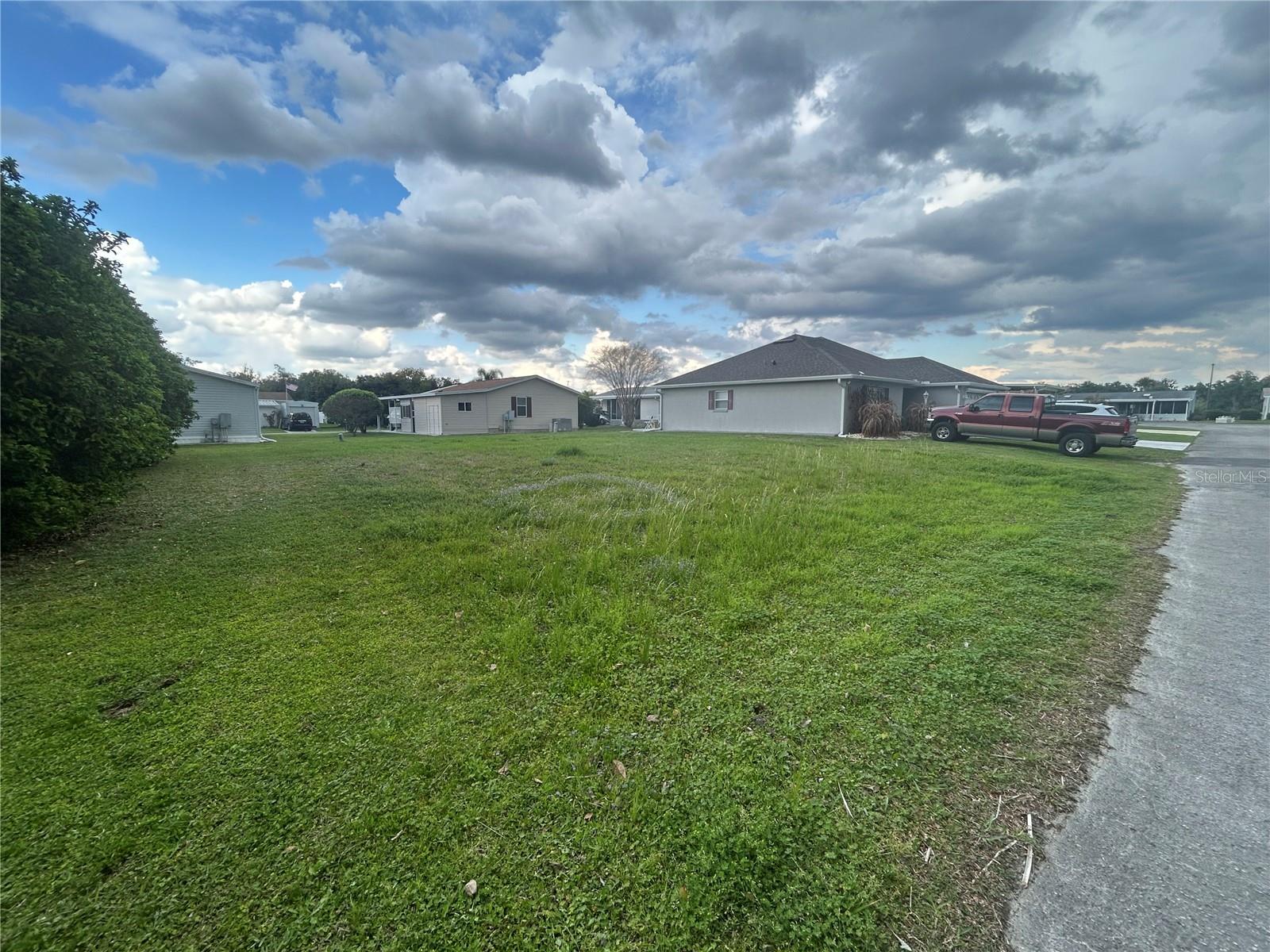 Discover the perfect opportunity to build your dream home on this beautifully situated vacant lot, located with easy access to the Brownwood Square, where you'll enjoy shopping, dining, and entertainment, along with nearby essentials like the Publix grocery store, banking and medical services.  This property is conveniently located right down road from the newly built Walmart store, making everyday errands quick and convenient. One of the standout features of this property is the freedom it offers.  Enjoy the benefits of being close to The Villages lifestyle without the associated restrictions.  This versatile lot offers the option to place a manufactured home, giving you flexibility in designing your ideal living space.  There is no restrictions placing a outdoor shed providing additional storage options for tools, hobbies or recreational items. Whether you're looking to build, invest, or create a peaceful Florida retreat, this property offers a rare opportunity in a rapidly growing and desirable area.