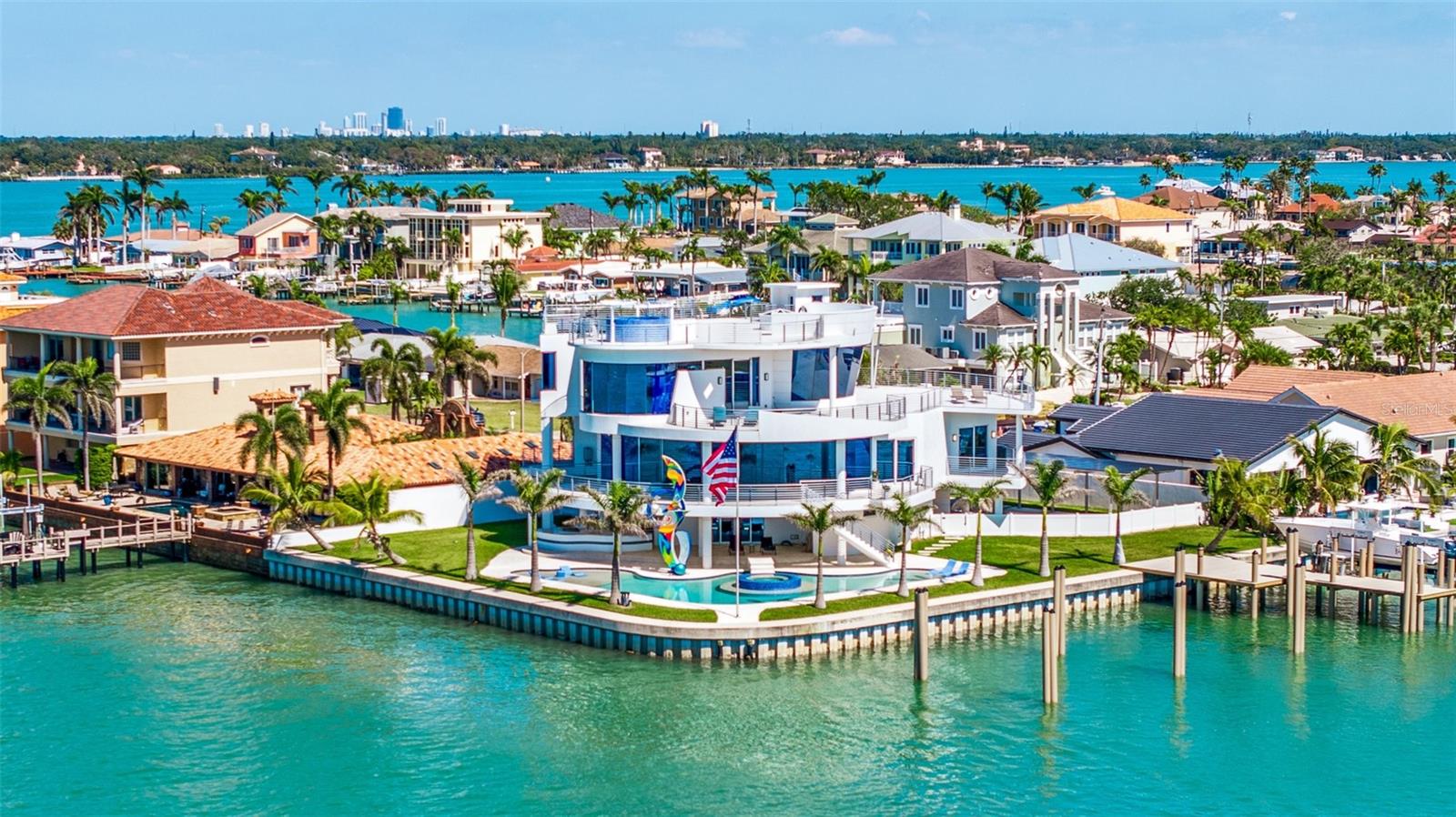 CAT 5 RATED HURRICANE HOME Ultra-Modern 6,428 Sq Ft Concrete Smart Home | Glass Elevator, Solar Average Electric Bill $125/Mo , Dock, Rooftop & Resort-Style Living
Crafted with precision and built for a lifestyle of luxury, innovation, and resilience, this 6,428 sq ft all-concrete smart home redefines modern waterfront living. Every element of this architectural masterpiece is engineered for performance, efficiency, and ease—from the poured concrete floors and roof to its expansive balconies that blend indoor and outdoor living.
A four-story, oversized glass elevator with a 1,400 lb capacity serves as the home’s vertical centerpiece, connecting each level with sleek sophistication. Power and utility are secured with a 48kW Generac generator, 1,000-gallon inground propane tank, four 200-amp electrical panels (including one dedicated to the generator), and 71 high-efficiency 400-watt solar panels, dramatically reducing monthly electric costs.
Security and comfort are built in with 1 1/4” thick, triple-Pane Kevlar-reinforced windows, automated blinds and drapes, and four 5-ton AC heat pump units for zoned climate control. The high-performance design continues outdoors with electric entry gates—featuring a custom modern abstract design, remotes, and a lighted keypad—and two vehicle turntables, eliminating the need to ever back out of the garage.
The resort-style 40,000-gallon pool features a beach entry, jacuzzi, laminar jets, and LED lighting, framed by an outdoor kitchen and a 20' modern abstract statue, offering both art and ambiance to your backyard entertaining. Head up to the rooftop jacuzzi with panoramic views, with plumbing already in place for a rooftop kitchen.
Built with the waterfront lifestyle in mind, the 265 ft seawall was raised 18” with a 36” concrete cap, leading to a brand-new (2025) dock with a 40,000 lb Decko lift, water, electric, and the capacity to accommodate a 135’ yacht with a 20’ beam the pilings can be moved to accommodate a 35 foot or more beam on a boat. A walkway entry completes the yacht-ready setup.
With every square foot thoughtfully designed and fortified, this home offers a level of craftsmanship and innovation rarely seen, delivering the ultimate in smart luxury living. Media room can also be used as a bedroom with closet and full bath with private balcony the POTENTIAL with this amazing opportunity is Must See.