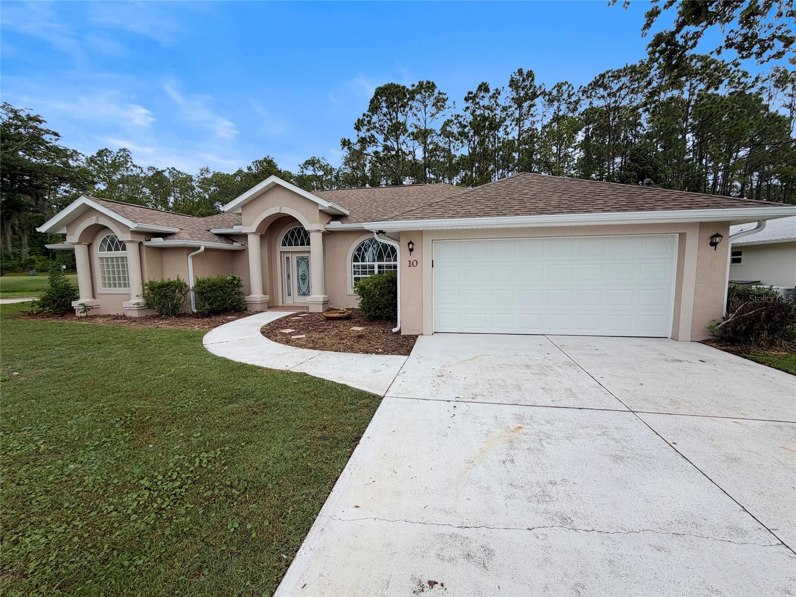 This three-bedroom, two-bathroom home in Palm Coast has been refreshed with significant updates throughout. A new roof, new HVAC system, and new water heater provide peace of mind, while fresh paint and new carpet in the bedrooms create a clean, move-in-ready interior. Inside, vinyl planked flooring flows across the living room, dining room, and great room, creating a cohesive and durable surface that ties these spaces together. The three bedrooms offer comfortable proportions, with the primary suite providing private retreat space. Two full bathrooms serve the home conveniently. The standout feature is the large screened-in porch overlooking the golf course, offering a serene outdoor retreat where you can enjoy views and fresh air year-round without the concern of insects or weather exposure. This space extends the home's usable living area and provides an ideal spot for relaxation or entertaining. This is a Fannie Mae HomePath property.