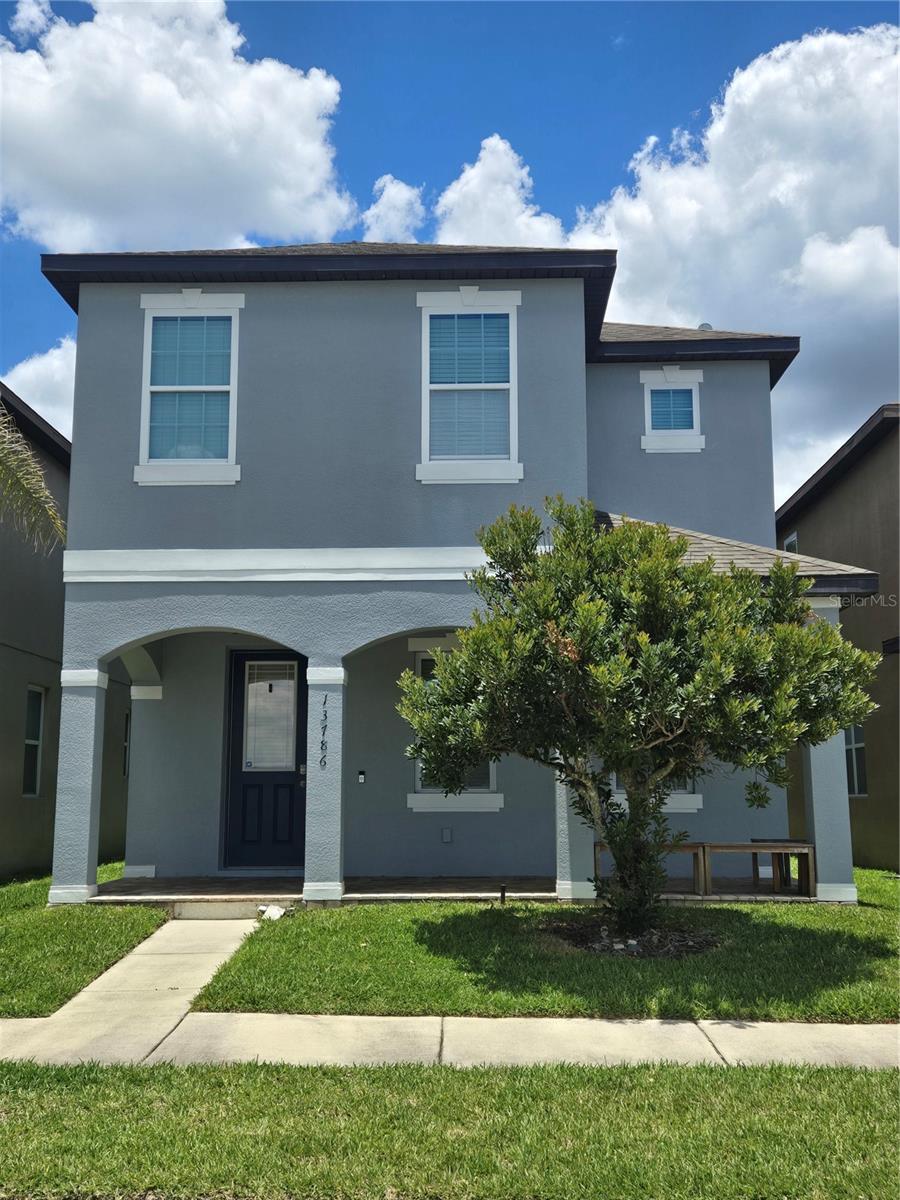 Experience the magic of Disney from the comfort of your own home in this beautiful four-bedroom, two-and-a-half-bath residence located in the sought-after Summerport Trail community of Windermere. Perfectly positioned, this home offers a rare opportunity to enjoy nightly VIP views of Disney fireworks right from your front porch. Built in 2015 and offering 2,236 square feet, the home features a thoughtfully designed, open-concept layout with tile flooring throughout the main living areas. The spacious kitchen is a true centerpiece, complete with granite countertops, 42-inch wood cabinetry, a breakfast bar, pantry, full appliance package, and abundant prep space—seamlessly flowing into the dining area and expansive great room, ideal for entertaining. The main level also includes a convenient half bath and rear access to a two-car garage, privately situated along a well-lit alleyway, preserving the neighborhood’s charming streetscape while offering secure and accessible parking. Upstairs accommodate the privacy of your four bedrooms with generously sized bedrooms including the primary suite featuring dual walk-in closets and a spa-like en-suite bath with dual vanities. A versatile loft provides the perfect setting for a media room or additional living space, while the upstairs laundry room adds everyday convenience. Residents of Summerport Trail enjoy easy access to a scenic, waterfront amenity center featuring a resort-style pool, fitness center, community gathering spaces plus a few short walking distance to your local grocery stores, restaurants and other amenities. Ideally located in a top-rated school district and just minutes from Disney, major highways (I-4 and 429), and additional shopping, dining options, healthcare, and entertainment. Perfect blend of comfort, convenience, and lifestyle. **More Pictures Coming Soon