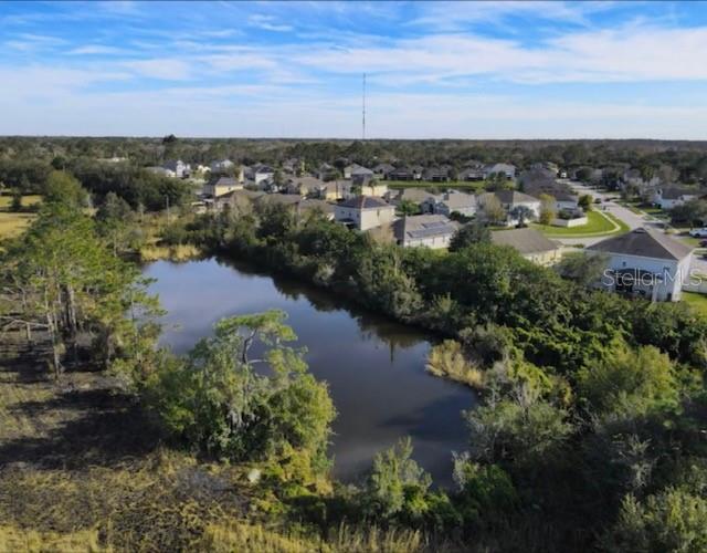 This expansive vacant lot offers an exceptional canvas to build your dream home, vacation escape, or private estate. Imagine a custom residence with a gated entrance, tennis or basketball court, playground, gazebo, or beautifully landscaped gardens filled with fruit trees and tropical plants—all centered around your own serene private pond.

With approval from the City of St. Cloud, there may be potential to develop additional single-family homes, making this a great option for builders, investors, or those planning for the future. Bordered on three sides by well-established residential communities, the location offers both privacy and potential.

Just 3–5 minutes from local shopping, schools, and everyday conveniences, and only a short drive to world-famous theme parks and attractions. The property includes electric and septic, with a 35-foot-wide entryway already in place.