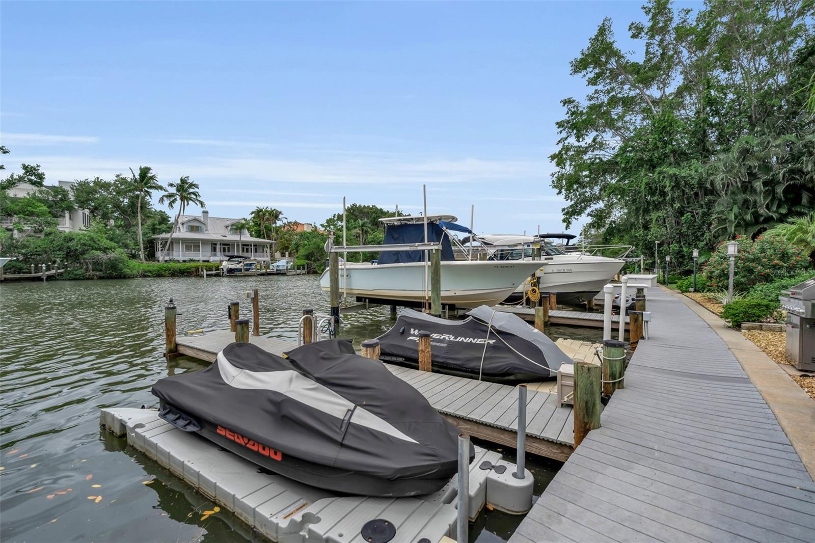 Waterfront elegance meets downtown convenience in Hudson Landings, one of Sarasota's most desirable West of Trail enclaves. **Now confirmed, the DEEDED BOAT SLIP accommodates a vessel up to 34 feet**, making this a rare opportunity for boating enthusiasts seeking direct access to Sarasota Bay and the Gulf of Mexico. Privately positioned along a tranquil canal, this exceptional ground-floor residence offers an effortless waterfront lifestyle just moments from downtown Sarasota's acclaimed dining, arts and cultural attractions.
Spanning 1,362 square feet, the thoughtfully curated interior features three bedrooms and two baths, blending timeless coastal sophistication with modern comfort. The open-concept design is filled with natural light and anchored by a beautifully updated kitchen appointed with granite countertops, stainless steel appliances and casual seating that flows seamlessly into the living and dining areas. Elevated ceilings enhance the sense of openness, while expansive windows invite the waterfront setting indoors.
The serene primary suite overlooks the bayou and community pool, creating a peaceful retreat framed by water views and lush tropical landscaping. Two additional guest bedrooms provide flexibility for family and friends. Hurricane-rated windows and sliders, a detached one-car GARAGE, and a heated community pool further enhance the ease of ownership. For the ultimate in convenience, the residence is offered FULLY FURNISHED, creating a truly turnkey opportunity to begin enjoying Sarasota's coveted waterfront lifestyle from day one.