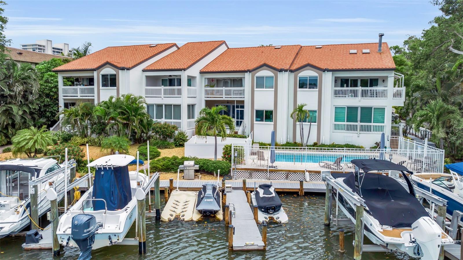 Waterfront elegance meets downtown convenience in Hudson Landings, one of Sarasota's most desirable west of-the-trail enclaves Privately positioned along a tranquil canal with a deeded dock and direct access to
Sarasota Bay, this exceptional ground-floor residence presents a rare opportunity to enjoy an effortless boating
lifestyle just moments from the city's vibrant cultural and culinary offerings.
Spanning 1,362 square feet, the thoughtfully curated interior features three bedrooms and two baths, blending
timeless coastal sophistication with modern comfort. The open-concept design is filled with natural light and
anchored by a beautifully updated kitchen appointed with granite countertops, stainless steel appliances and
casual seating that flows seamlessly into the living and dining spaces. Elevated ceilings enhance the sense of
openness, while expansive windows invite the waterfront setting indoors.
The serene primary suite overlooks the bayou and pool, creating a peaceful retreat framed by water views and
lush tropical surroundings. Two additional guest bedrooms offer flexibility for visiting family and friends.