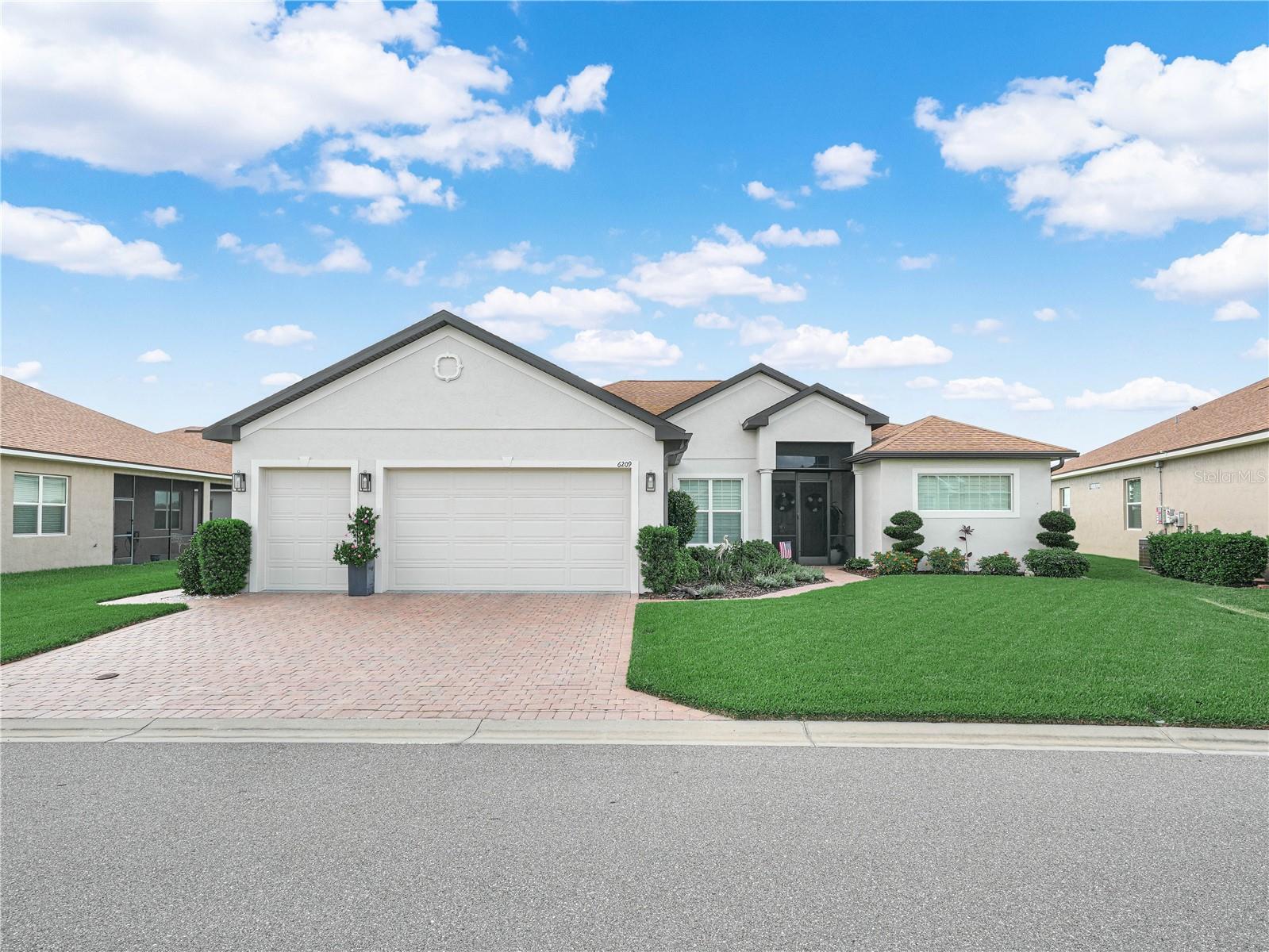 Modern Elegance! 6209 Pinehurst Loop Winter Haven, Florida 33884. Built in 2021, this custom designed home is located in Lake Ashton, one of Central Florida's Premier 55 Plus community.  Perfectly positioned on a quiet street this exceptional home with Northwest exposure offers effortless luxury with modern upgrades. Offering excellent curb appeal with a well manicured lawn and mature landscape this home has an expanded driveway, extended golf cart entry, paver walkway to the back lanai, and a fresh coat of exterior paint (May 2026).  Built for both sophistication and peace of mind, this block construction home offers over 2,500 square feet of living area and golf course views.  Upon entering the home thru the screened entry, the 6 panel Double Front door opens into a spacious living area with beautiful lighting fixtures, trey ceiling & Engineered hardwood floors that flow seamlessly in the LR, Den, Dining Room, Kitchen & Flex Room. In the Living Room, a custom built wall unit accents the area and is a focal point in the elegant gathering spaces.  The formal dining area shares the space, while the chef's kitchen showcases upgraded Cabinetry, Tiled backsplash, Silestone countertops with Eased Edge, Granite composite undermount kitchen sink, RO water system at the kitchen sink, Kitchen Aid Stainless Steel appliances, 36" cooktop with Extended Hood, Built In Wall Oven and Oversized Island with cabinets, great for entertaining.  A custom built dry bar with lighting, leathered countertop and back splash accents the hall.  The thoughtfully designed split floor plan includes 3 spacious bedrooms, 2 baths, a private study/den with French glass doors, and an oversized flex room with Wash Sink, Washer/Dryer, Wine Refrigerator, Upgraded cabinetry, Quartz counter top and Tiled backsplash. The elegant Primary Suite is a must see! The impressive En-Suite offers a separate water closet, dual sink vanity, a spacious glass enclosed walk in shower with Pietra Art Premier Marble Tile, foot rest and floor to ceiling tile. The boutique style clothing room offers California closet designs with a central dressing island. Plantation Shutters accent the room and allows natural light to filter thru the space. The 8 ft. door ways in this home compliment the high ceilings and the window treatments (Plantation shutters and Power shades) are elegant and designed for comfortable luxury living. Access to the outdoor living area is available thru the dinette area & the living room. You'll transition from the LR to the Lanai thru Triple Glass Sliding Doors that stack and disappear into a pocket providing an unobstructed view of the golf course. The Outdoor living area is equally impressive with a covered and extended screened lanai with epoxy flooring. A pad was added for your grilling pleasure. The double car garage with separate golf cart entry has epoxy flooring and pull down stairs on the attic access door. Make an appointment today to tour this elegant home. Lake Ashton features a Main Clubhouse with Outdoor Pool, Movie Theater, Bowling Lanes, Card, Craft and Billiard rooms, Fitness Center, Bocce Courts, Tennis and More.  Residents also enjoy the Health and Fitness Center with large indoor pool, Pickle Ball, Tennis Courts, Fitness Center and MORE! 2-18 Hole Golf Courses are located behind the secure gates of Lake Ashton and Golf Memberships are Available. Boat Slip Rentals and Storage Rentals are available in Lake Ashton.