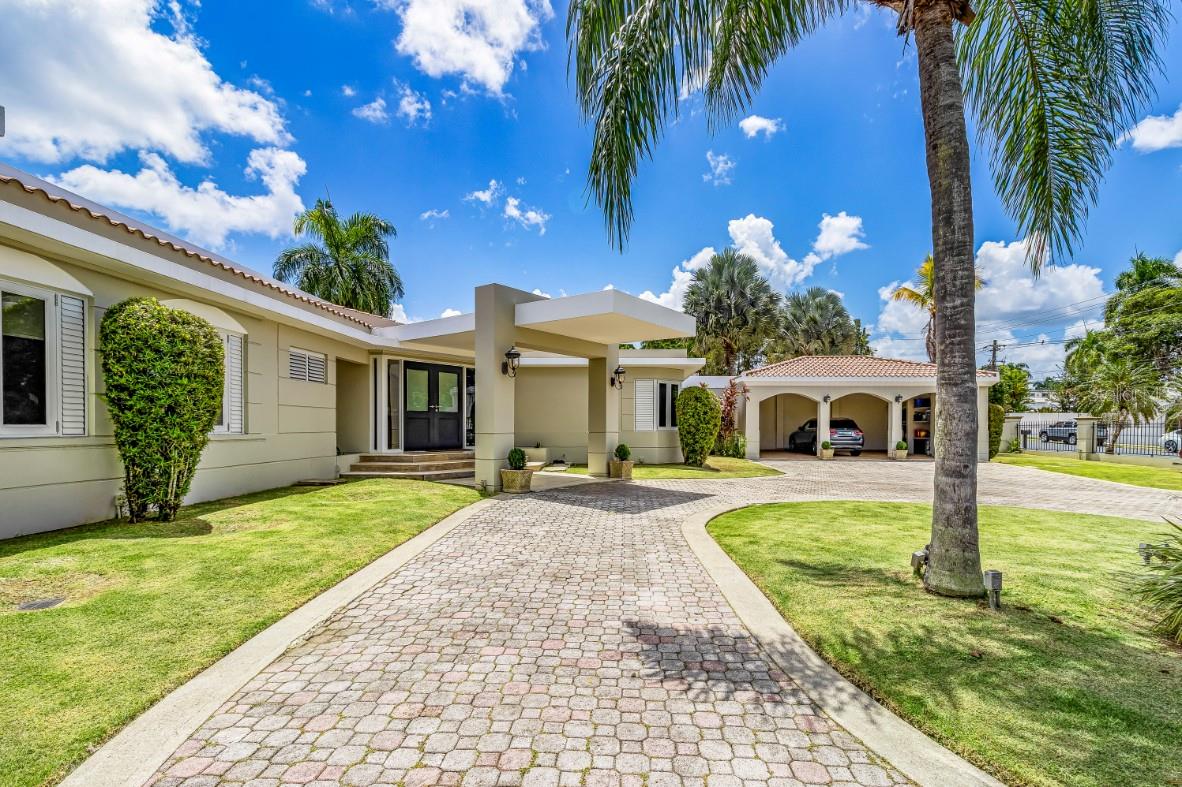 Presenting an Iconic Masterpiece in Santa Maria: San Juan's Premier Luxury Community!
 
Built in the 1990s and meticulously renovated in both 2004 and 2017, this exceptional residence stands as a testament to timeless Mediterranean design. Spanning 5,353 square feet of interior space, complemented by 2,210 square feet of outdoor living, this home offers a grand total of 7,563 square feet of luxury living.
 
Upon entering, you'll be greeted by timeless marble floors and high ceilings that display opulence throughout this one level estate. Every detail has been carefully considered to ensure the utmost in comfortable living.

The main bedroom wing encompasses four generously proportioned bedrooms, with the potential to convert one area into a fifth bedroom, making this home perfect for families of all sizes. The principal bedroom and its accompanying bathroom enjoy full patio vistas that invite the lush greenery of the outdoors inside.

There are a total of 7.5 bathrooms, ensuring convenience and privacy for all. Additional highlights include a service room and a well-appointed office, as well as a 3-car garage with ample storage space. There is also a multiple-use room, that can be either a gym, another family room, or a guest bedroom.

Sitting on an expansive lot of 4,139 square meters, this property offers unparalleled privacy. The backyard is an entertainer's dream with a picturesque setting. Enjoy a refreshing dip in the pool year-round and take advantage of the vast green yard to create your own sports and recreational courts.

Located in a prime spot within Orquidea Street, this property boasts a predominantly flat lot—hard to find in Santa Maria. It comes fully equipped and with a power generator. 

Santa Maria is a gated community with 24/7 surveillance, providing a safe and family-oriented environment. It is ideally situated close to the finest schools, businesses, restaurants, and nightlife in San Juan.

Don't miss your chance to tour this unique gem, available for sale for the first time. Contact us today to schedule your private viewing.
