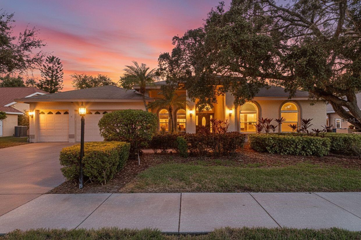 Welcome to 771 Weathersfield Drive — a 4-bedroom, 3 full bath home with a private office and 3-car garage, located in one of Dunedin’s most desirable communities. This spacious residence is thoughtfully designed for comfort, functionality, and true Florida living. Enjoy peaceful lake and conservation views from your private backyard oasis. The pool and deck area provide the perfect setting for relaxing or entertaining, while the solar-heated pool and solar panel water heater add energy efficiency and long-term savings. This home offers full hurricane protection with impact-rated windows and a hurricane-rated front entry door. A new small garage door enhances curb appeal and functionality. The kitchen features updated cabinets, creating a fresh and functional space for everyday living. Additional highlights include updated family room flooring, a water softener system, and a single garage bay with its own AC unit — ideal for a workshop, home gym, or flexible bonus space. Located just minutes from Honeymoon Island State Park, the Pinellas Trail, charming Downtown Dunedin, and TD Ballpark, this home offers convenient access to beaches, parks, dining, shopping, and vibrant community events. Roof (2024)AC (2019)Pool & deck refinished (2017)Primary bedroom carpet replaced (2017)New hurricane-rated front entry door (2025)New small garage door (2025)
