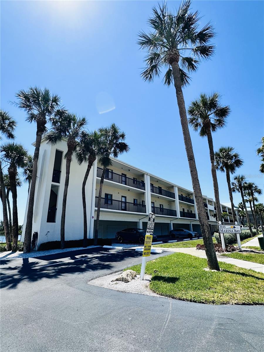 Sun-drenched unit with prime waterfront views! This elevated residence features a seamless open floor plan overlooking your private boat slip, with 15000lb lift. Enjoy modern tile flooring throughout, beautifully upgraded walk-in showers, and the convenience of inside laundry. Resort-style living at its best with a heated pool, private beach access, and three assigned parking spaces.