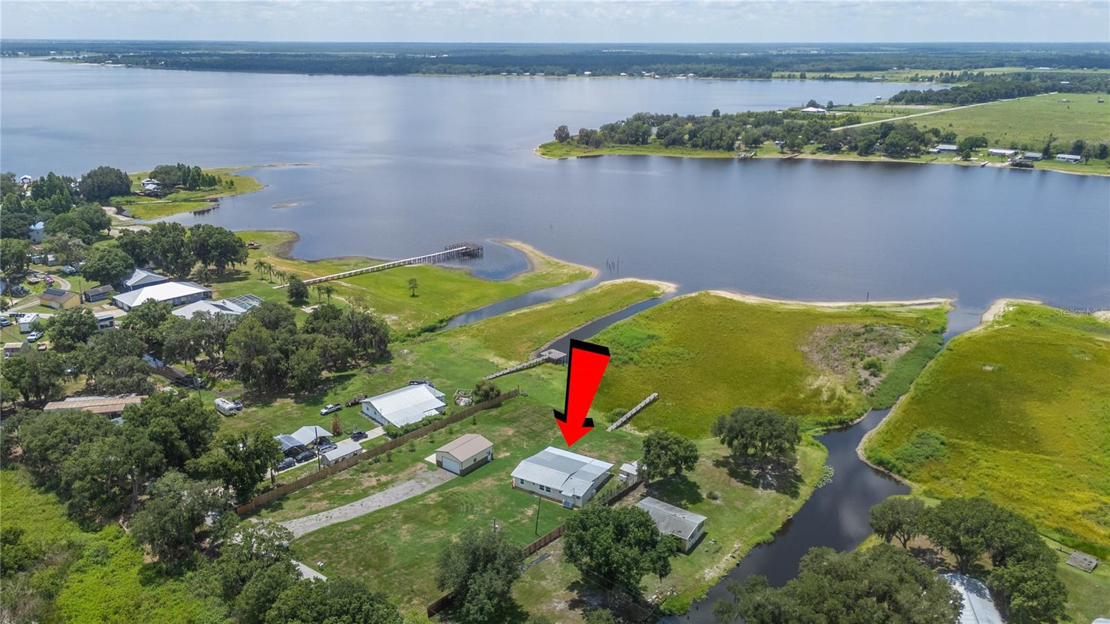 Enjoy peaceful lakeside living in this beautifully updated 3-bedroom, 2-bath home situated on 1.22 acres with a 24x30 detached garage along the shores of Lake Buffum in Fort Meade. Offering 1,741 square feet of thoughtfully designed living space as well as a private dock, this property combines modern updates with the tranquility of country, waterfront living. 

Step inside to an open floor plan filled with natural light from large windows that showcase the scenic surroundings. The spacious kitchen has been refreshed with new countertops, updated cabinetry, and a stylish backsplash, making it the perfect space for cooking and entertaining. The laundry room is conveniently close yet out of the way off the kitchen and includes the washer and dryer. 

The generously sized primary suite provides a relaxing retreat with a walk-in closet and an en-suite bathroom featuring a walk-in shower and a garden tub. Two additional bedrooms have been updated with new carpet and offer flexibility for family or guests. 

Outdoor living is just as impressive with an expansive 460-square-foot screened-in porch overlooking the lake—ideal for enjoying your morning coffee, hosting friends, or unwinding at the end of the day. The 1.22-acre property also features a 24x30 detached garage/workshop with plenty of space for storage, hobbies, or projects, as well as a smaller detached shed for additional storage. An outdoor fish cleaning station offers added convenience for anglers and could also serve as the perfect setup for an outdoor kitchen. For added peace of mind, the home is equipped with a Generac generator.

With beautiful lakefront views, modern updates, and plenty of indoor and outdoor living space, this move-in-ready home offers the perfect blend of comfort, functionality, and peaceful Florida living. Don't miss the opportunity to make this lakeside retreat your own!

USDA FINANCING AVAILABLE FOR ELIGIBLE BUYERS, WITH NO MONEY DOWN. CALL TODAY FOR MORE DETAILS.