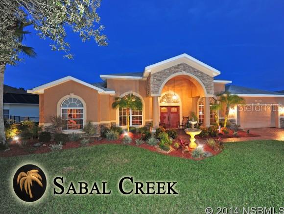 A warm and inviting pool home in the exclusive Sabal Creek gated community that has been meticulously maintained and expertly remodeled with the highest quality. Outdoor landscape lighting around the entire home adds to the personality and character. Freshly sealed pavered driveway and walkways guide you to your custom front doors or to your private screened pool enclosure and back yard with Gorgeous lake views that satisfy your eyes with every glance. Interior offers Custom Tigerwood Flooring and tile throughout, professionally Painted interior and Exterior, and top of the line stainless appliances in your gourmet kitchen. Granite Counters throughout the kitchen and bathrooms, ample storage, and much more. Get ready to relax or play in your extraordinary saltwater, solar-heated pool that is surrounded by fountains and has a heated jacuzzi. This Johnson Built 4 bedroom 3 bathroom plus office split-plan home is zoned for the best "A" rated schools in Port Orange, conveniently located with easy access to shopping, I-95, the beaches, restaurants and more. Dont miss this opportunity to live in your dream model home! ;Water: City