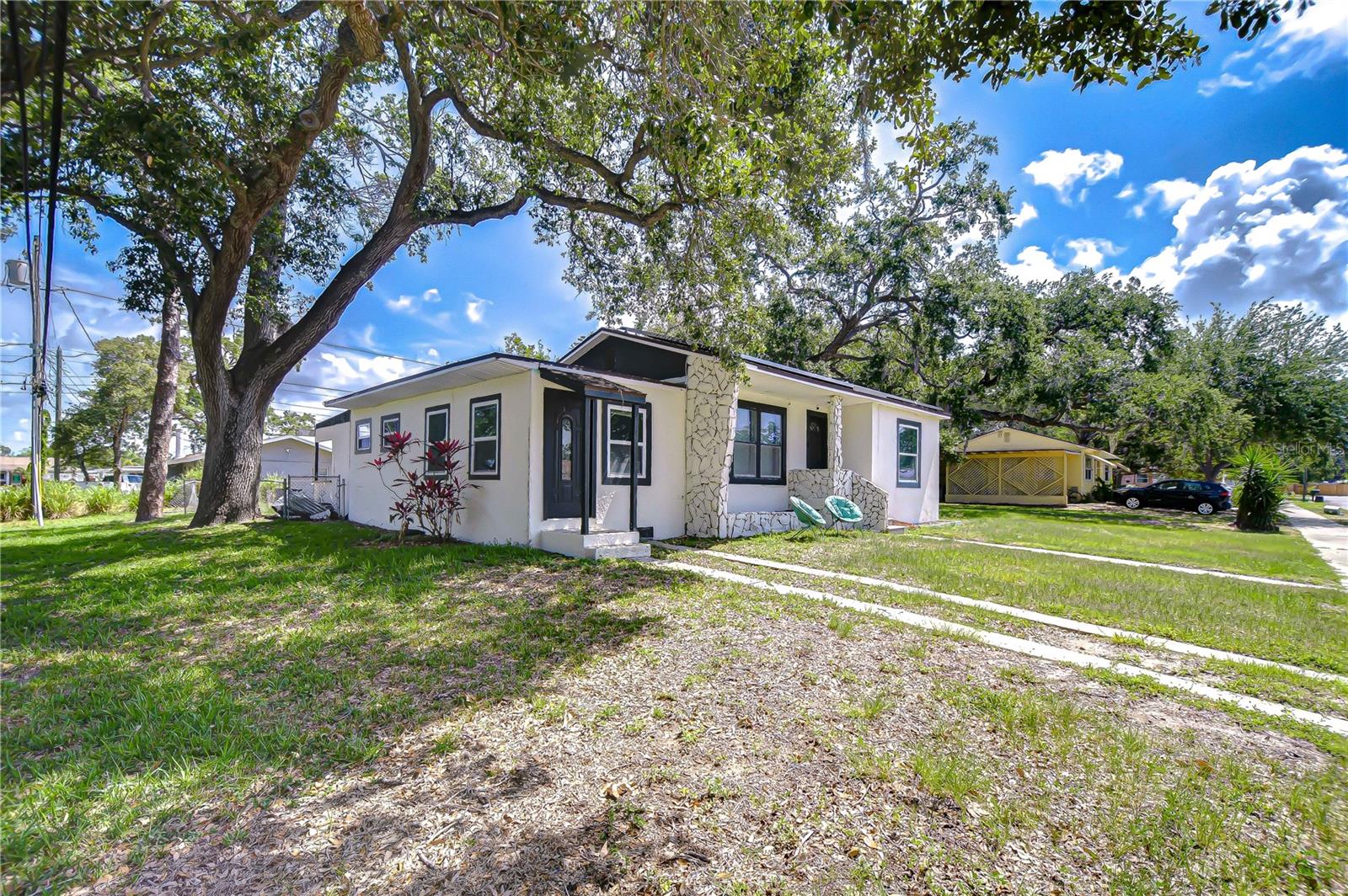 This charming 3-bedroom, 2-bath Gulfport home presents an excellent investment opportunity with a tenant already in place through 04/30/2027, providing immediate rental income for the next owner. Situated on a spacious fully fenced corner lot with a massive shed/garage perfect for storage, hobbies, or workspace needs.  Inside, you’ll find a bright and inviting floor plan with sleek laminate flooring flowing throughout the living room, kitchen, and dining areas. The kitchen offers abundant storage, including dual pantry closets surrounding the refrigerator. Both bathrooms have been tastefully updated, while energy-efficient Tesla solar panels and a REEM tankless water heater help keep utility costs low.  The primary suite includes a private en-suite bathroom with a relaxing jetted tub as well as its own separate entrance, offering added flexibility and privacy. The additional guest bedrooms are generously sized and filled with natural light. Located just one block from the Pinellas Trail and conveniently positioned between Downtown Gulfport and St. Petersburg’s award-winning Gulf beaches, this home offers easy access to local restaurants, eclectic shops, entertainment, and waterfront attractions. Only 10 minutes to the beach, 10 minutes to Downtown St. Pete, and approximately 30 minutes to Tampa International Airport, this property combines location, lifestyle, and investment potential all in one. Don’t miss this exceptional Gulfport investment opportunity!