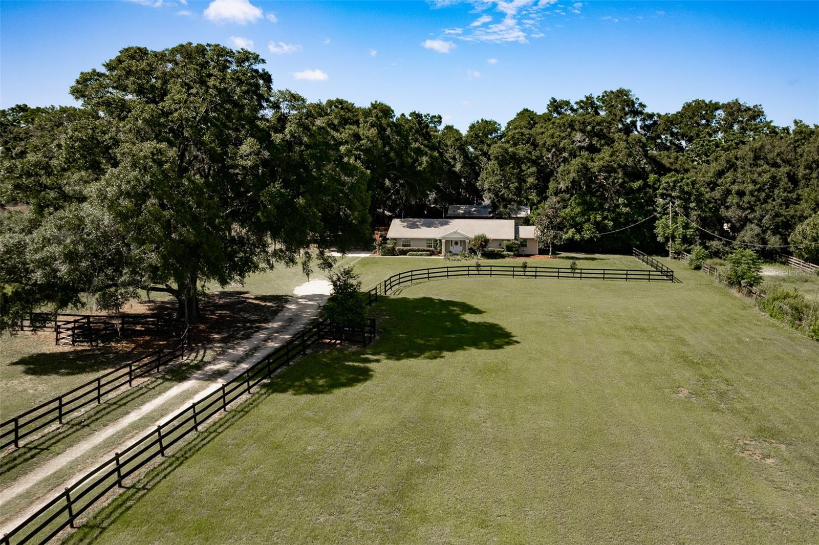 Nestled on 4.90 picturesque acres, this charming and modest 3-bedroom, 2-bath home with an office/bonus room offers the perfect blend of comfortable living and beautiful country surroundings. Located in SW Ocala close to everything! Featuring a desirable split-bedroom floor plan, the open living room, dining area, and kitchen create a warm and inviting space for everyday living.

Remodeled in 2020, the home showcases thoughtful upgrades including maple cabinetry, granite countertops, white oak wood flooring, and  Carrara marble countertops in both bathrooms. The spacious primary suite features a soaking tub, separate walk-in shower, and well-designed closet with custom built-ins, while every closet throughout the home has built-in storage for added organization.

While the home itself is cozy and functional, the true centerpiece of this property is the land. The nearly five-acre setting boasts 3 large paddocks and a round pen each with water, lush green pastures, majestic mature oak trees. Equestrian enthusiasts will appreciate the shed-row barn complete with three 12 X 12 stalls and a 2-story tack room / feed room, and wash rack making it ideal for horses or hobby farming. 

After a day outdoors, relax at the barn on the covered back porch, the perfect spot for barbecues, entertaining friends, or simply taking in the tranquil views. 20 minutes to World Equestrian Center and Horse Park. Home was updated in 2020, with new jenn-air range, Bosch dishwasher, new wood, carpet and tile floors. New roof, A/C and water heater in 2020. Bosch refrigerator 2026. Barn was built in 2012. 30 AMP RV plugin at barn. Additional smaller barn could make a great chicken coop.