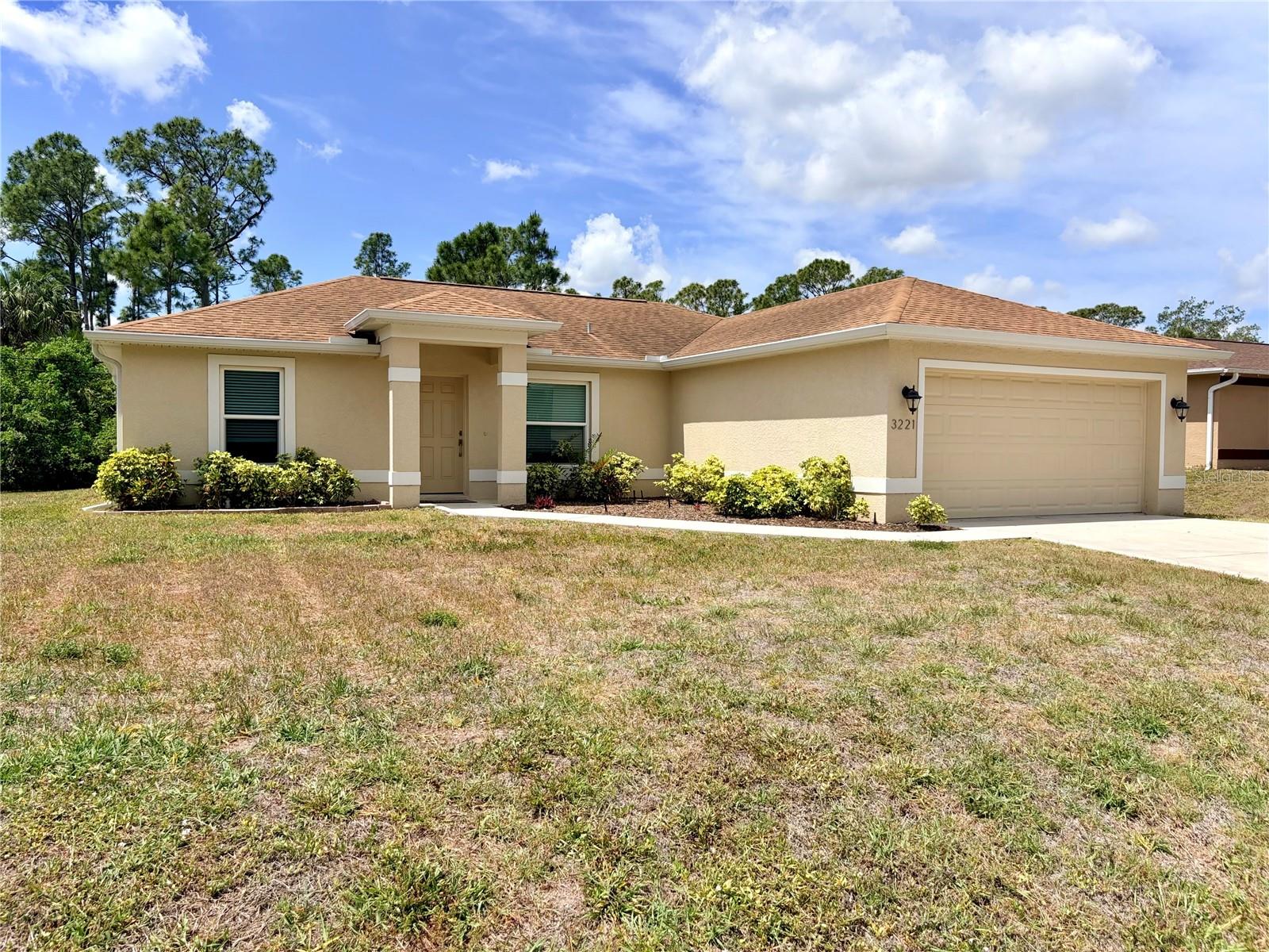 Ultimate Peace of Mind Meets Modern Luxury! Safely nestled high and dry in Flood Zone X and fully equipped with impact windows, this stunning 2017 custom-built North Port home is a rare find. Tucked away on a quiet street behind mature, lush landscaping, this 3-bedroom, 2-bathroom residence offers a meticulously designed open floor plan and tile throughout. Step inside to discover a bright, sun-drenched living space featuring soaring ceilings and tranquil views of your secluded backyard. The heart of the home is an expansive chef’s kitchen, boasting a large center island, on trend warm white cabinetry, gleaming granite countertops, and stainless steel appliances. The spacious living room flows seamlessly into a dining area framed by a beautiful picture window overlooking your private outdoor oasis. Designed for privacy, the split floor plan features a secluded owner’s retreat complete with oversized windows, a walk-in closet, and a spa-like en-suite bath with dual vanity sinks, granite counters, and a walk-in shower. Two generously sized guest bedrooms share a refined second bathroom, perfectly matching the home's high-end finishes. Step out onto the oversized screened-in lanai to enjoy total peace and tranquility, all while being just minutes away from top-rated schools, fabulous shopping, and dining.