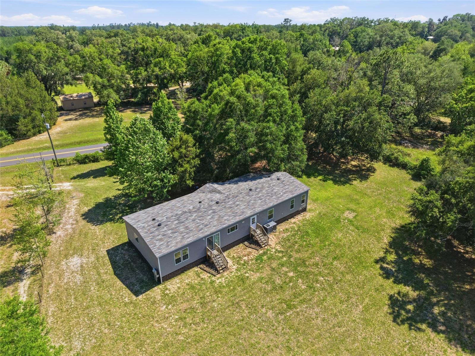 Where modern comfort meets peaceful country living in the heart of Lake City. Situated on a beautiful 1-acre lot, this stunning 2022-built home offers 5 spacious bedrooms, 3 full bathrooms, and over 2,200 square feet of thoughtfully designed living space.

Step inside to discover an open-concept layout filled with natural light, featuring a large chef-inspired kitchen with an oversized island, abundant cabinetry, and seamless flow into both the main living room and additional family room — perfect for entertaining, relaxing, or hosting gatherings.

The split-bedroom floor plan creates a private primary suite retreat, while four additional bedrooms provide flexibility for family, guests, a home office, or hobby space. Outside, enjoy the freedom and privacy of country living with room to roam, garden, or simply relax in the peaceful surroundings. Enjoy wildlife in the serenity of the beautiful natural setting while still being conveniently located just minutes from shopping, dining, entertainment, and excellent local restaurants.

Perfectly positioned close to Florida’s famous crystal-clear springs and the breathtaking Suwannee River, this property offers the ideal balance of outdoor adventure and everyday convenience. Whether you enjoy boating, kayaking, fishing, hiking, or simply soaking in North Florida’s natural beauty, this location truly has it all