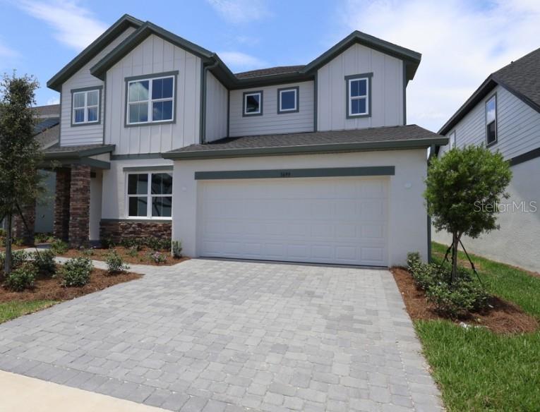Under Construction. David Weekley’s Bradley plan showcases signature craftsmanship and stylish finishes throughout. Enjoy a charming front porch, private study with French doors, and a beautifully appointed kitchen featuring light cabinetry, quartz countertops, built-in ovens, cooktop, and an oversized island. The open-concept family room flows to an extended covered lanai with private water and wooded views. This versatile home offers dual Owner’s Retreats, including a secondary Owner’s Suite on the main level, plus a guest suite with a full bath. Upstairs features the primary Owner’s Retreat and three additional bedrooms. A 2-car garage provides added convenience. Located in Oakfield at Mount Dora, within walking distance to Publix and dining, and just minutes from Downtown Mount Dora, Grantham Point, and the 453 Connector for easy access to Orlando.